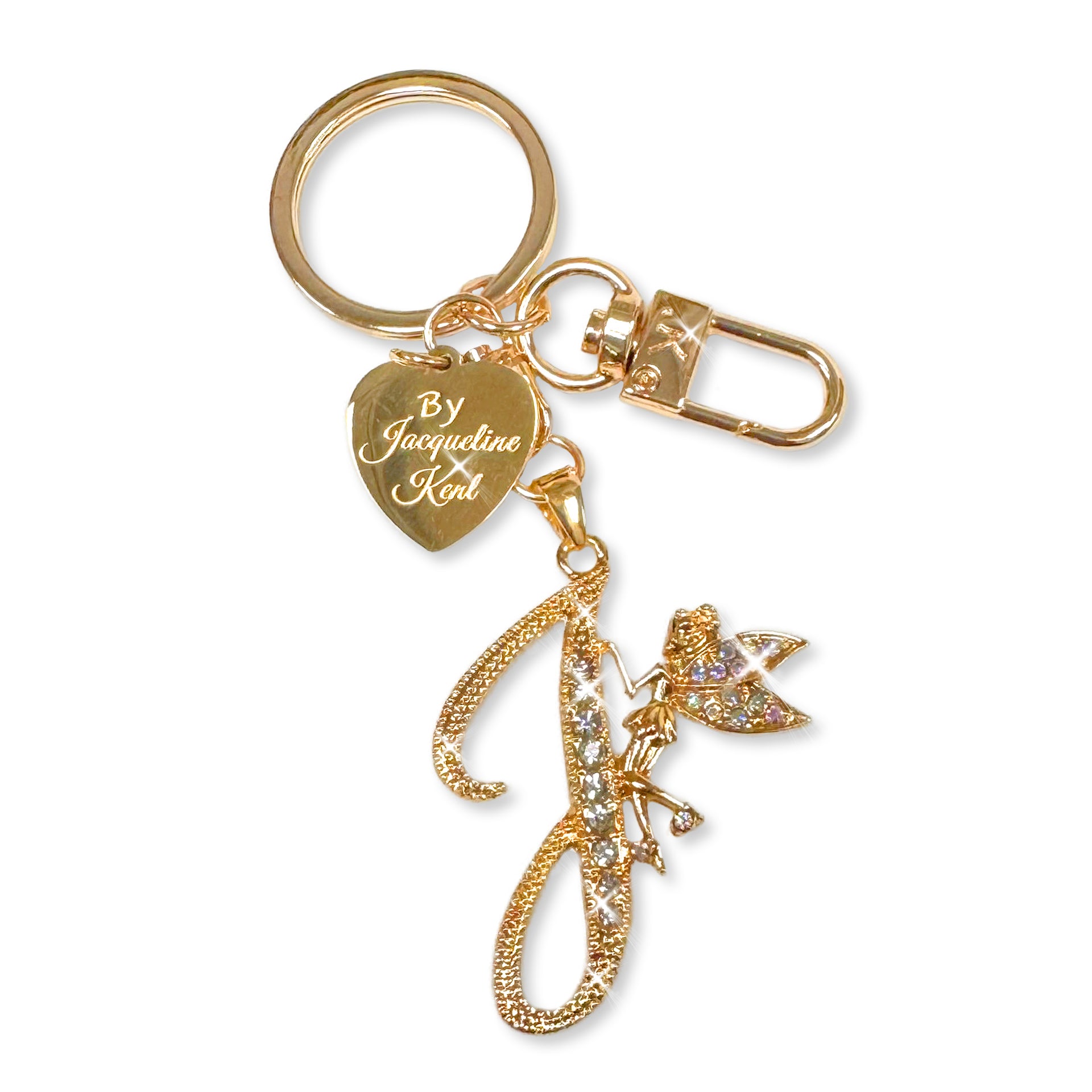 Gold and crystal embellished keychain with decorative letter 'J' and heart-shaped Jacqueline Kent branded tag on a white background