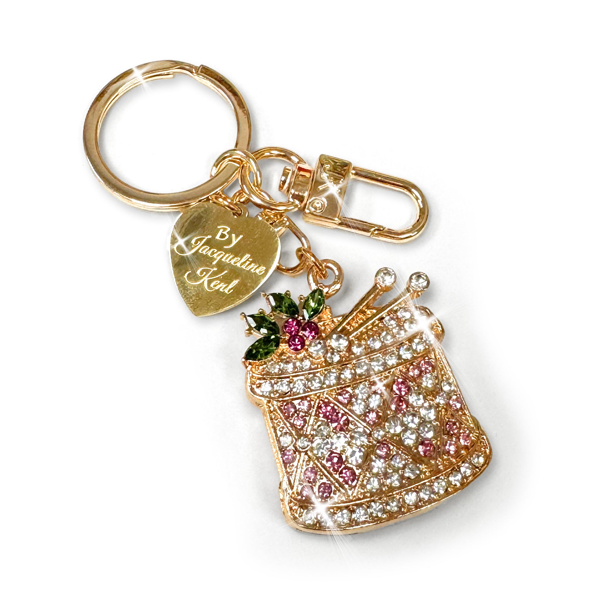 Gold drum purse charm/keychain in pink, clear, and green rhinestone details with a ‘Jacqueline Kent’ branded heart tag on a white background