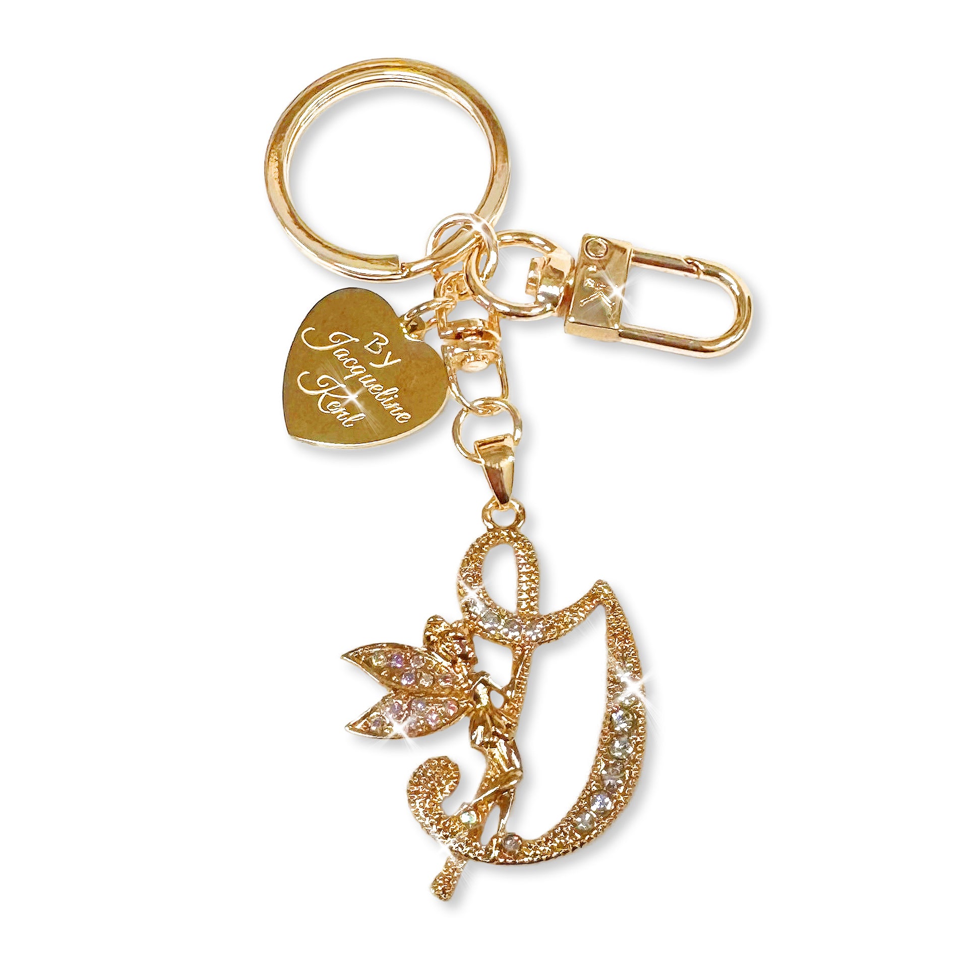 Gold and crystal embellished keychain with decorative letter 'G' and heart-shaped Jacqueline Kent branded tag on a white background