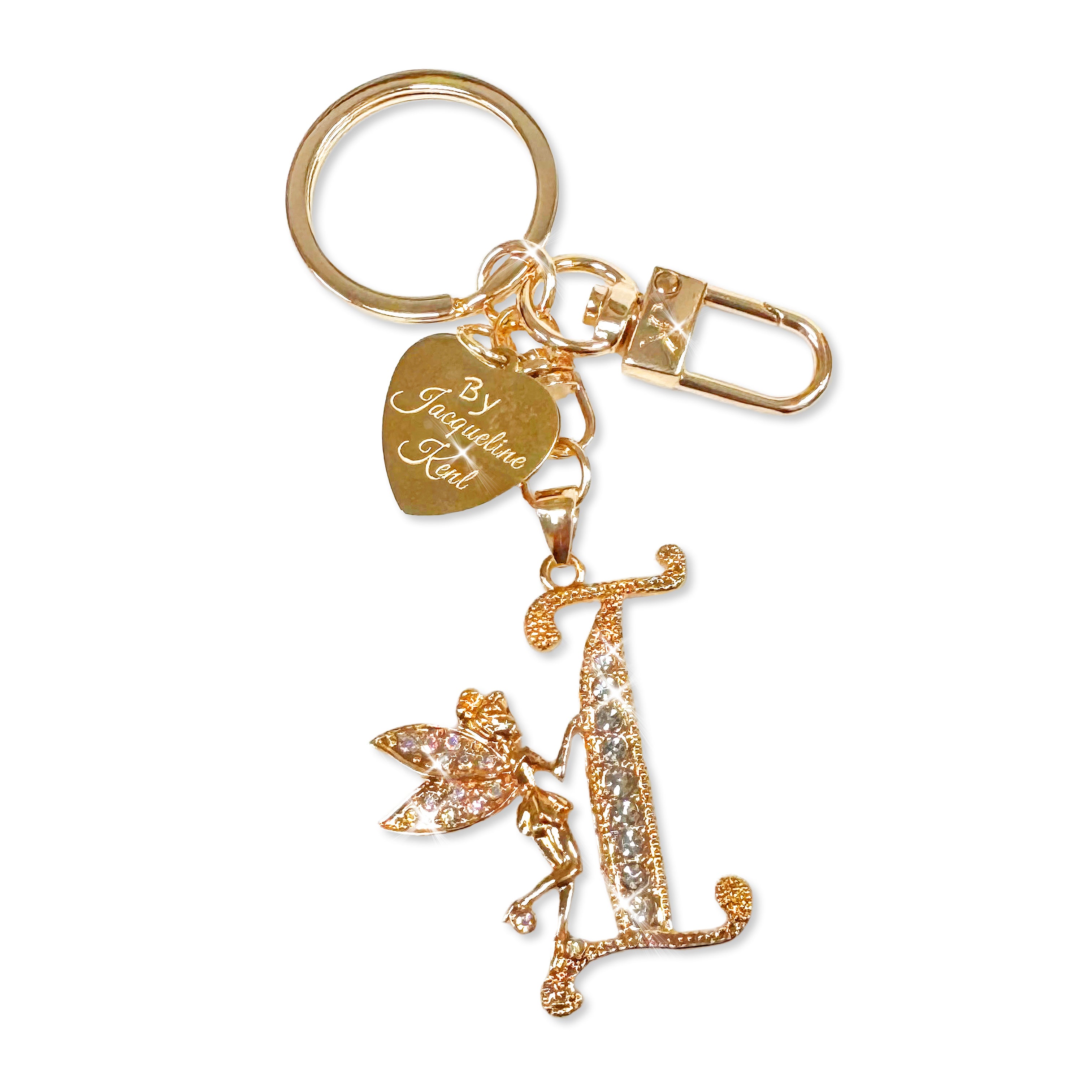 Gold and crystal embellished keychain with decorative letter 'I' and heart-shaped Jacqueline Kent branded tag on a white background