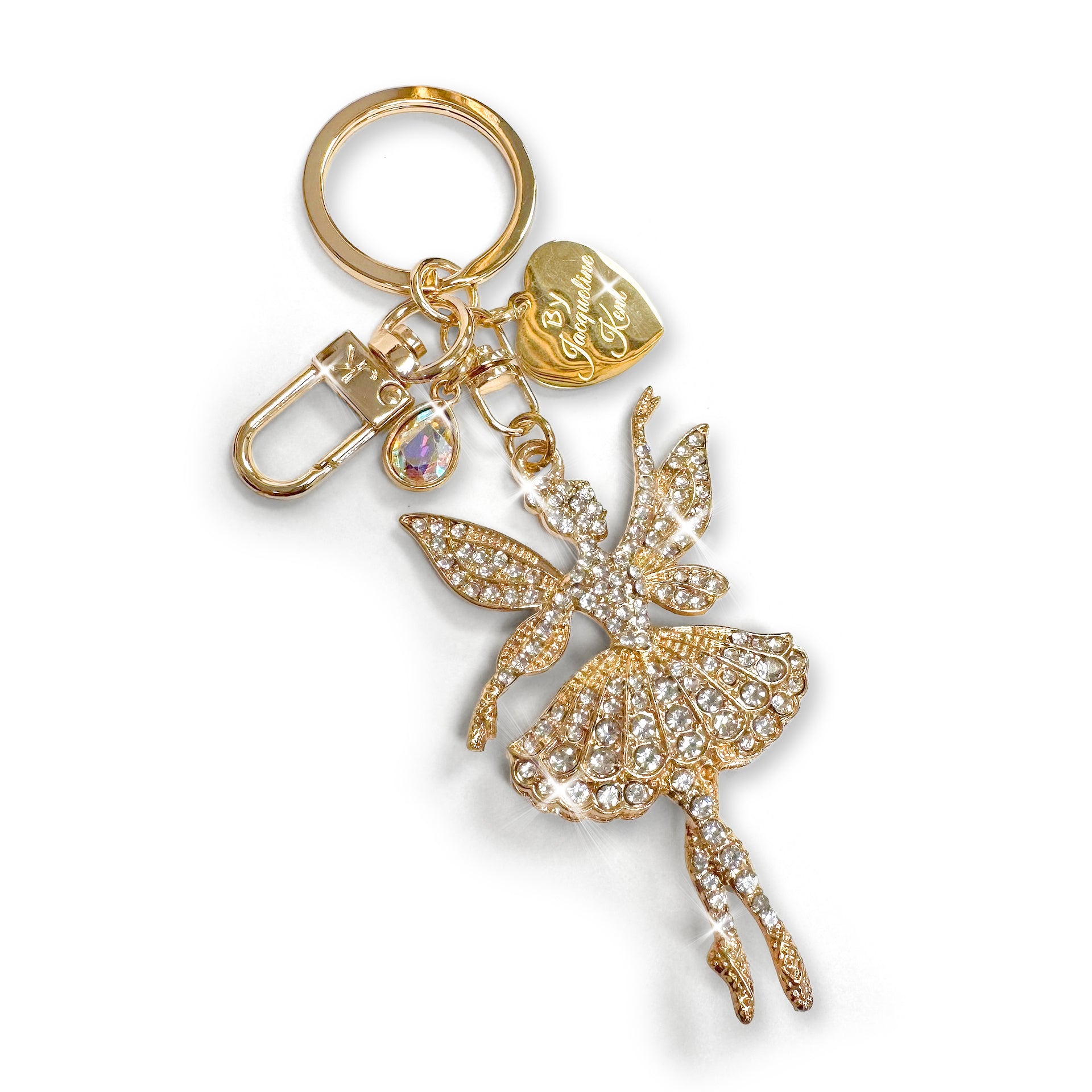 Gold sugar plum fairy purse charm/keychain with clear rhinestone detail a AB crystal charm and heart shaped Jacqueline Kent branded tag on a white background