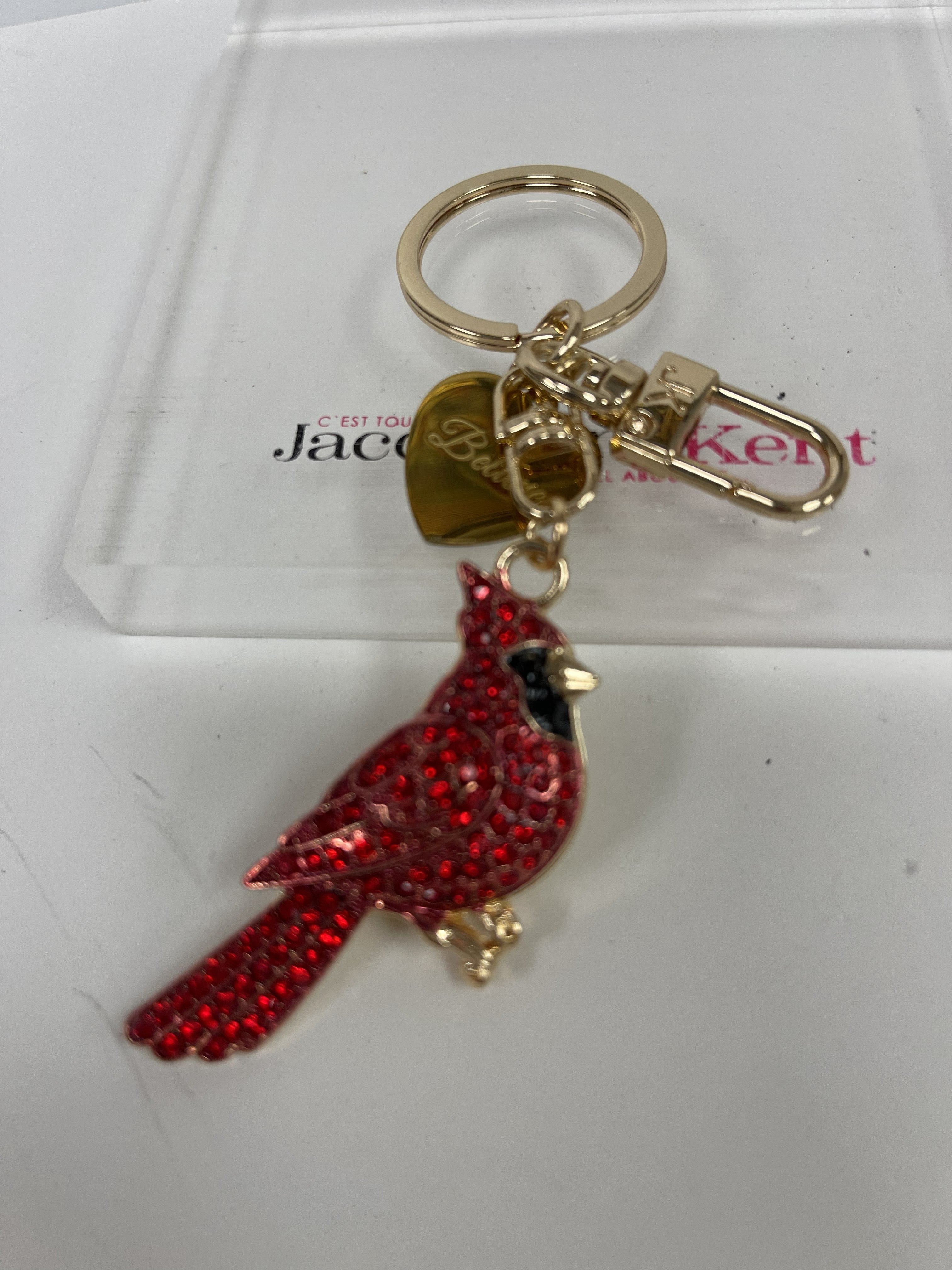 Red cardinal bird purse charm/keychain with red and black rhinestones with gold accents on a white background