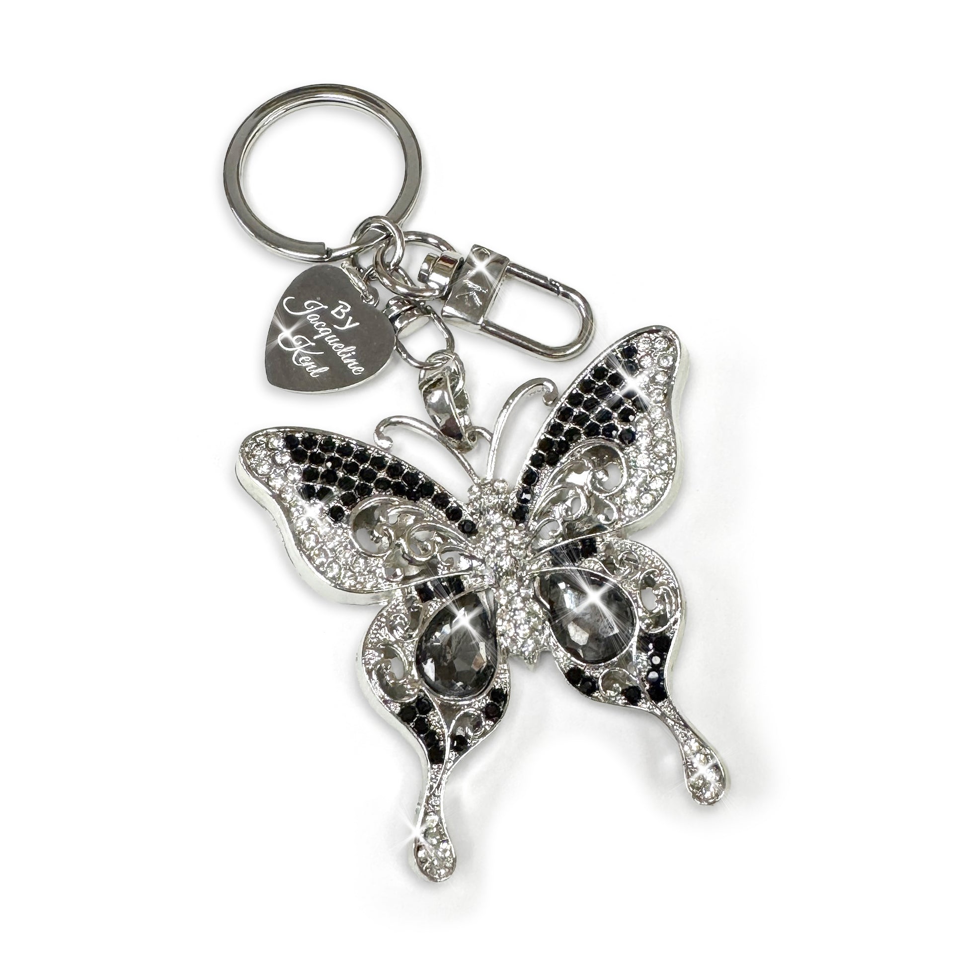 Butterfly keychain in silver with black and white crystal accents with heart charm on a white background