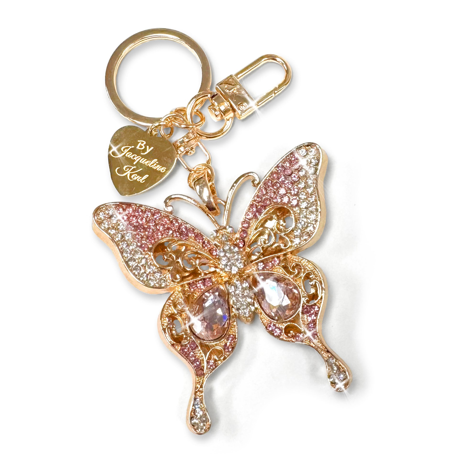 Butterfly keychain in gold with pink and clear rhinestones on a white background