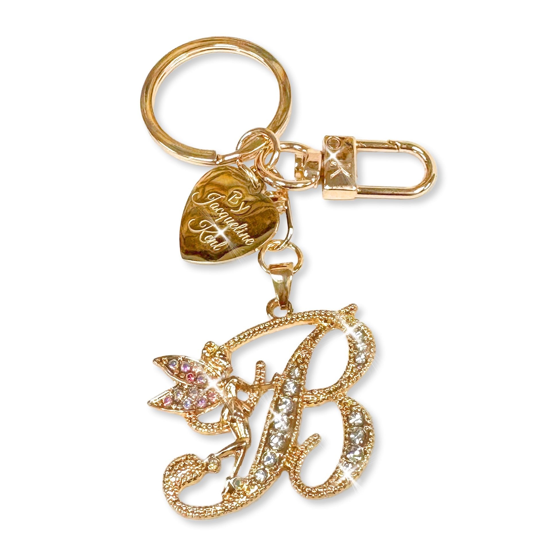 Gold and crystal embellished keychain with decorative letter 'B' and heart-shaped Jacqueline Kent branded tag on a white background