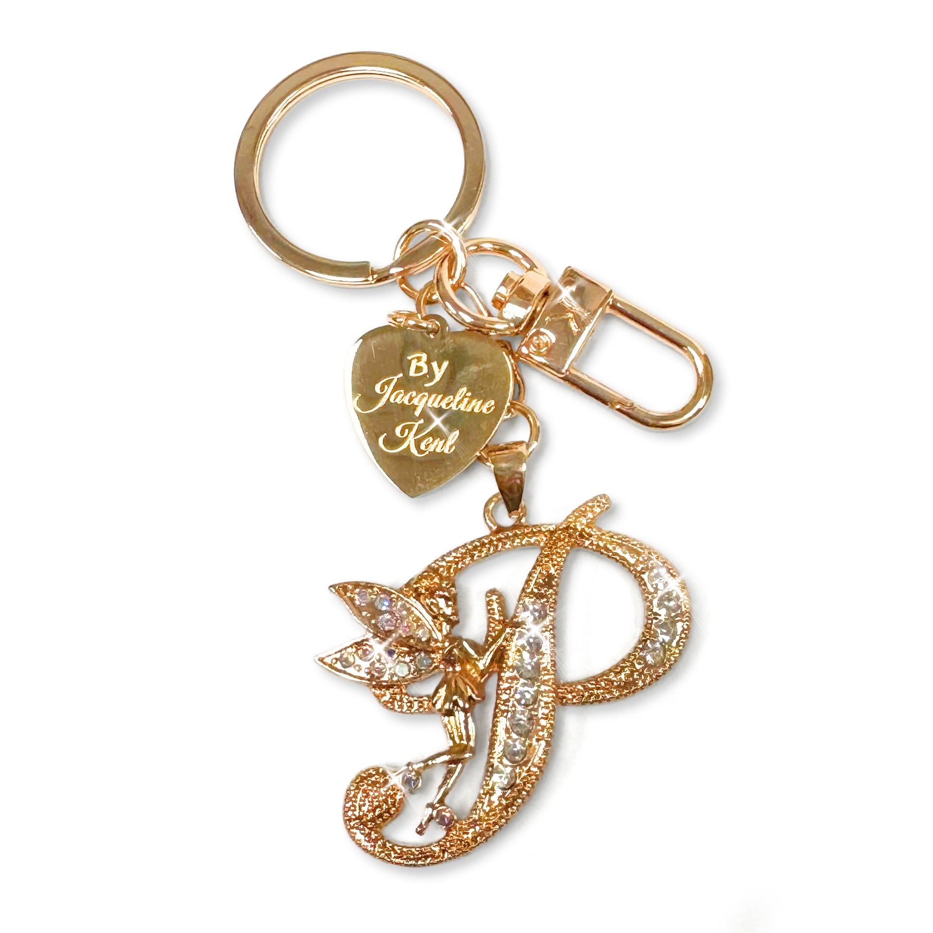 Gold and crystal embellished keychain with decorative letter 'P' and heart-shaped Jacqueline Kent branded tag on a white background