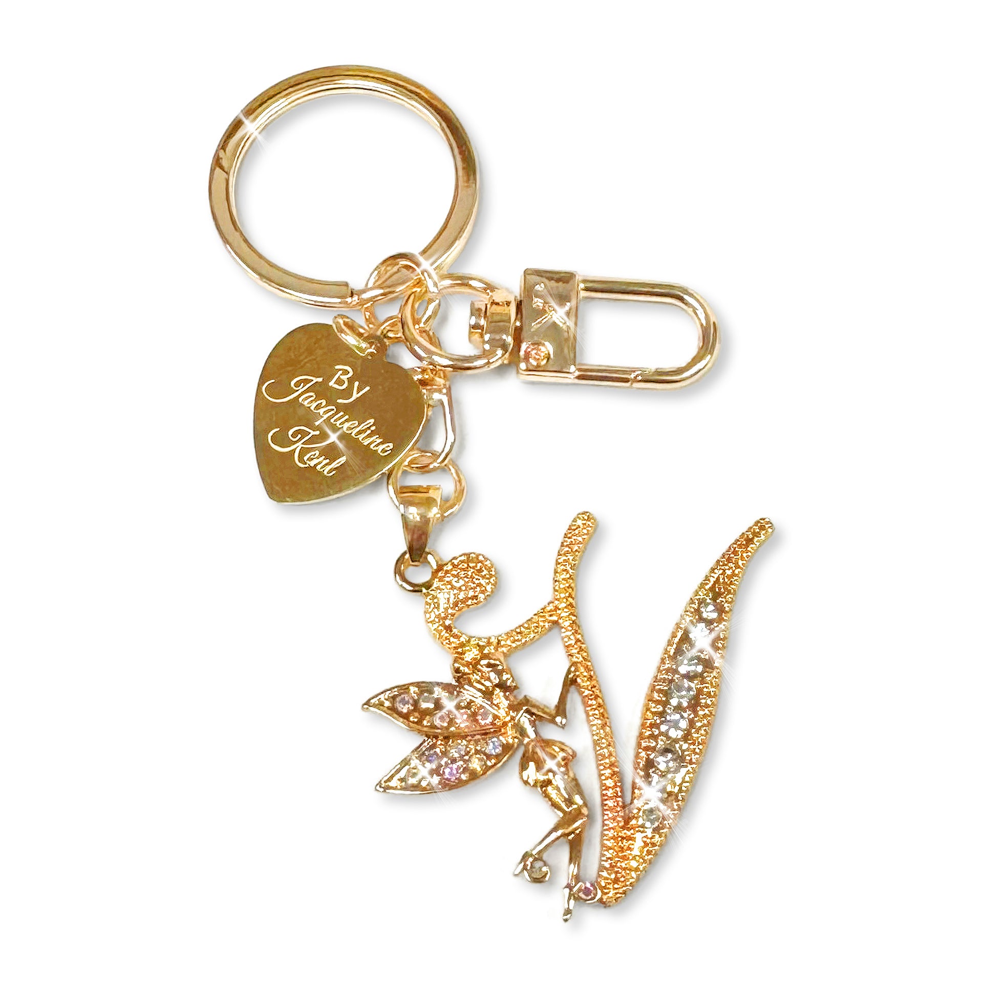 Gold and crystal embellished keychain with decorative letter 'V' and heart-shaped Jacqueline Kent branded tag on a white background