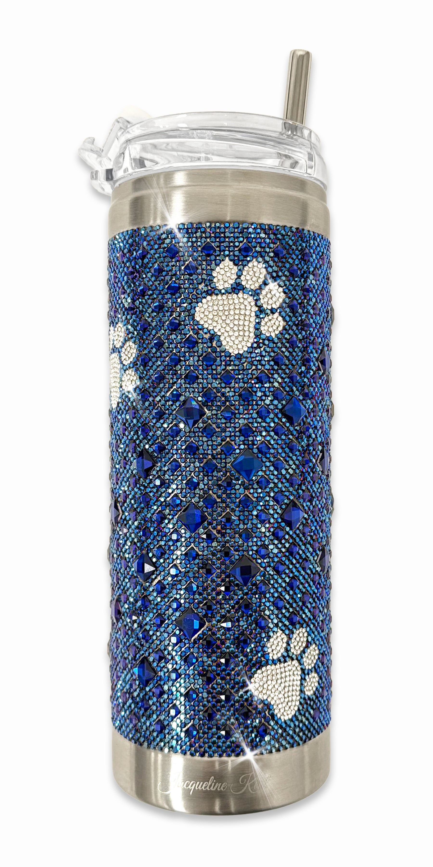 Tumbler with blue rhinestone pattern and silver paw prints on a white background