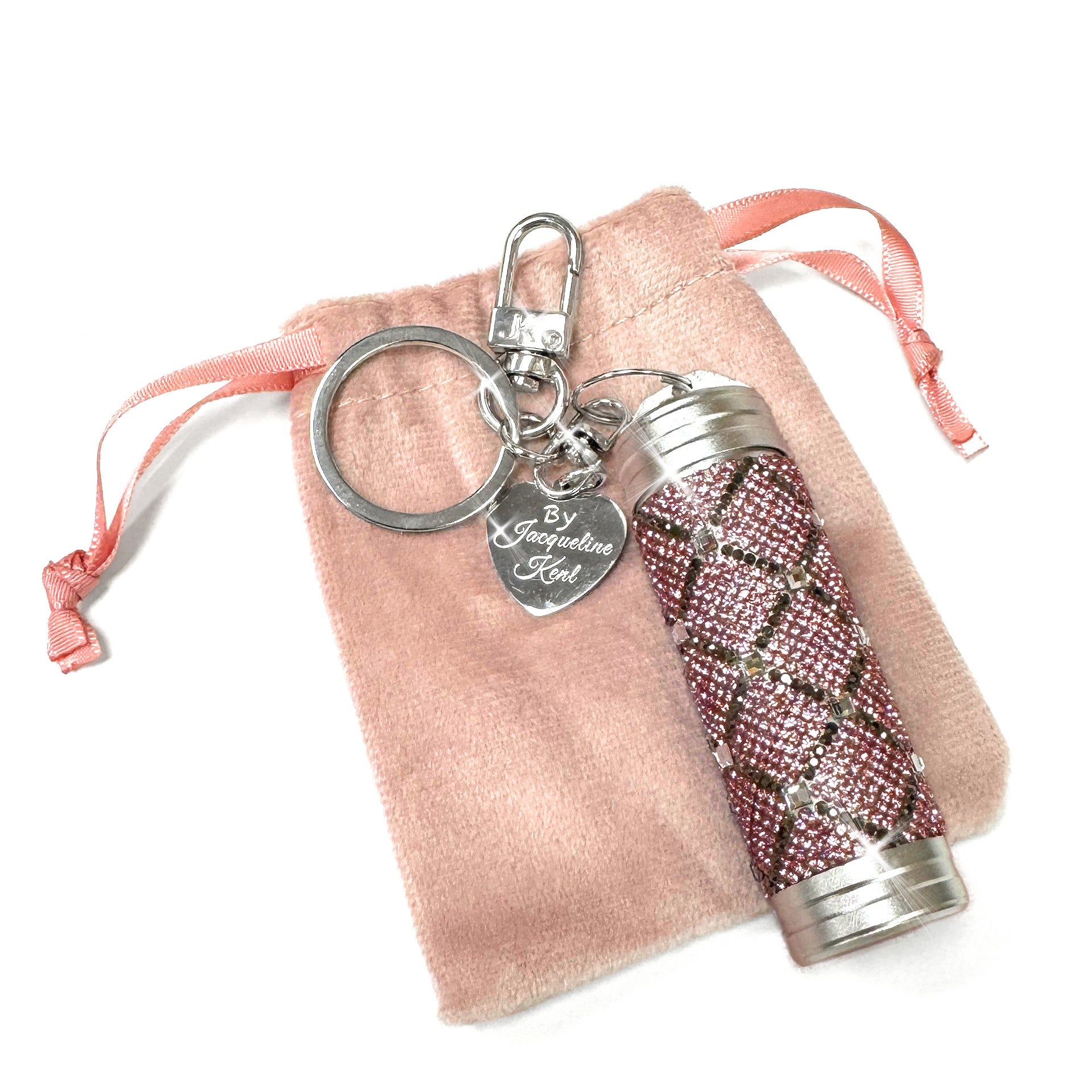 Decorative keychain/purse charm with pink rhinestone embellishments on a pink drawstring bag