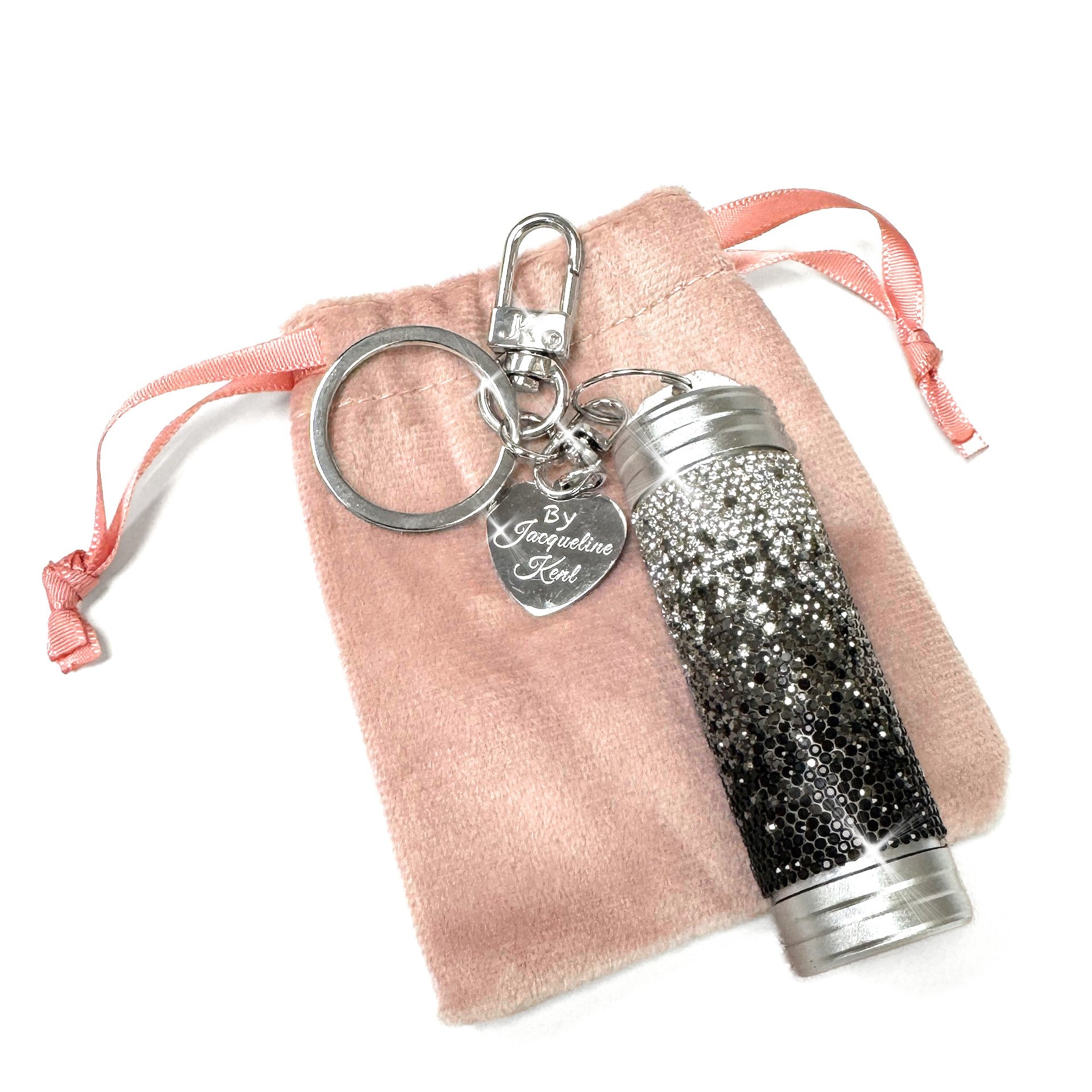 Black and silver ombre glittery mini tumbler keychain/purse charm on a pink drawstring bag