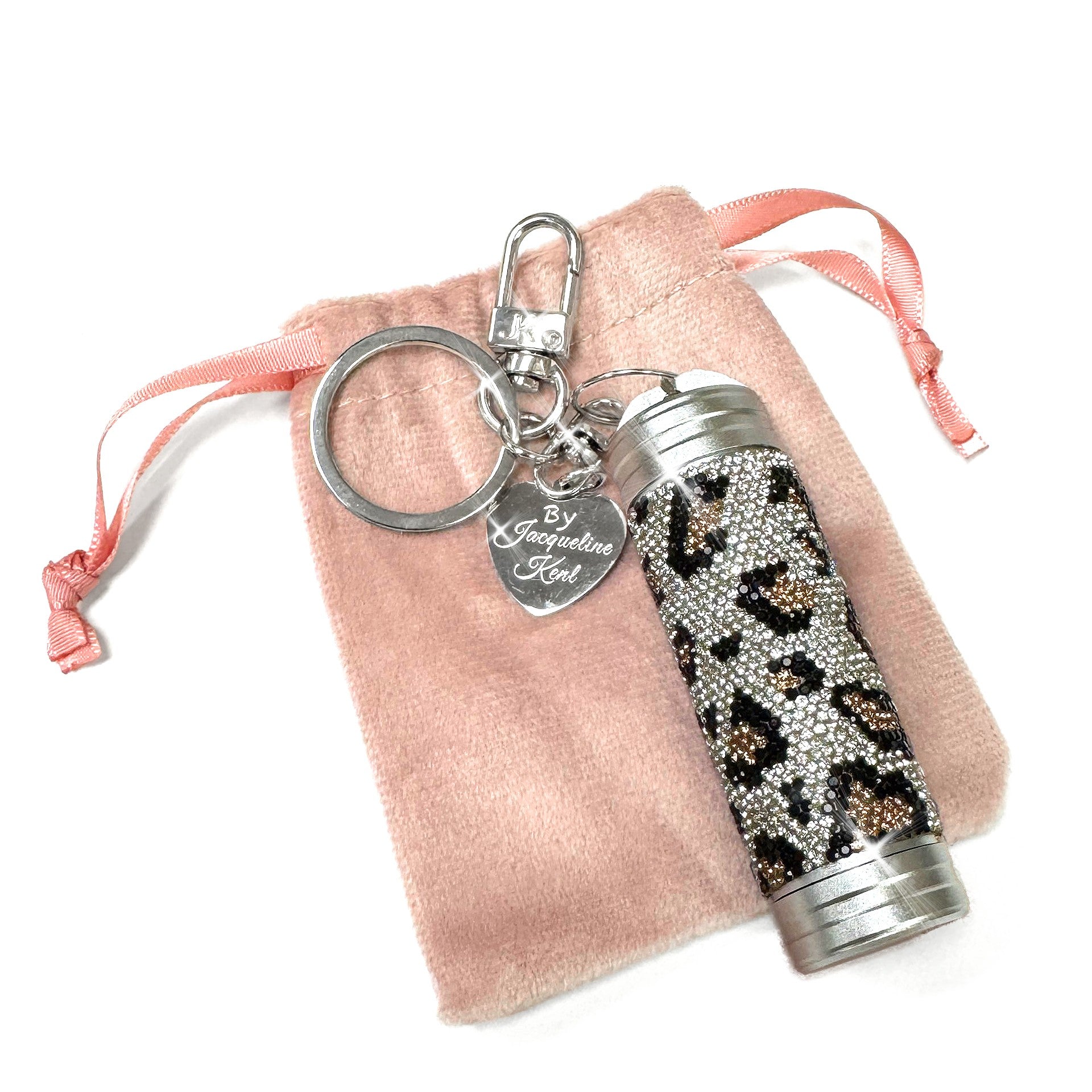 Rhinestone leopard print mini tumbler charm with pink drawstring bag on a white background
