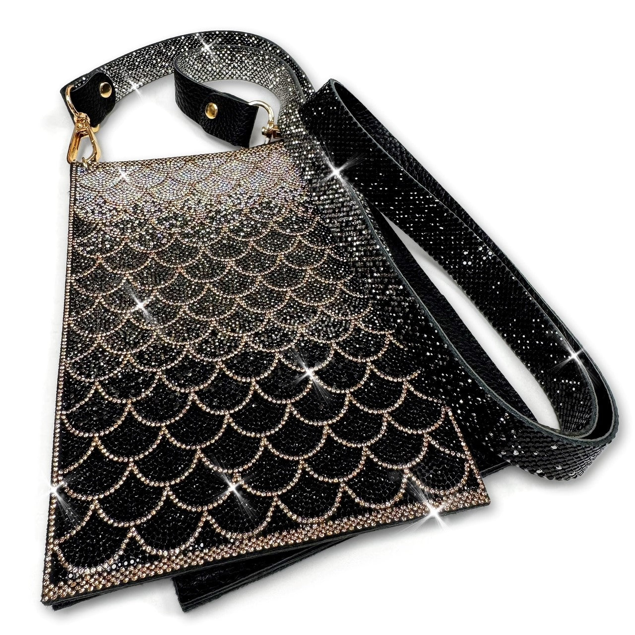 Cell phone pouch with glittery black, hematite, silver and gold rhinestones in a mermaid scale pattern with adjustable strap on a white background