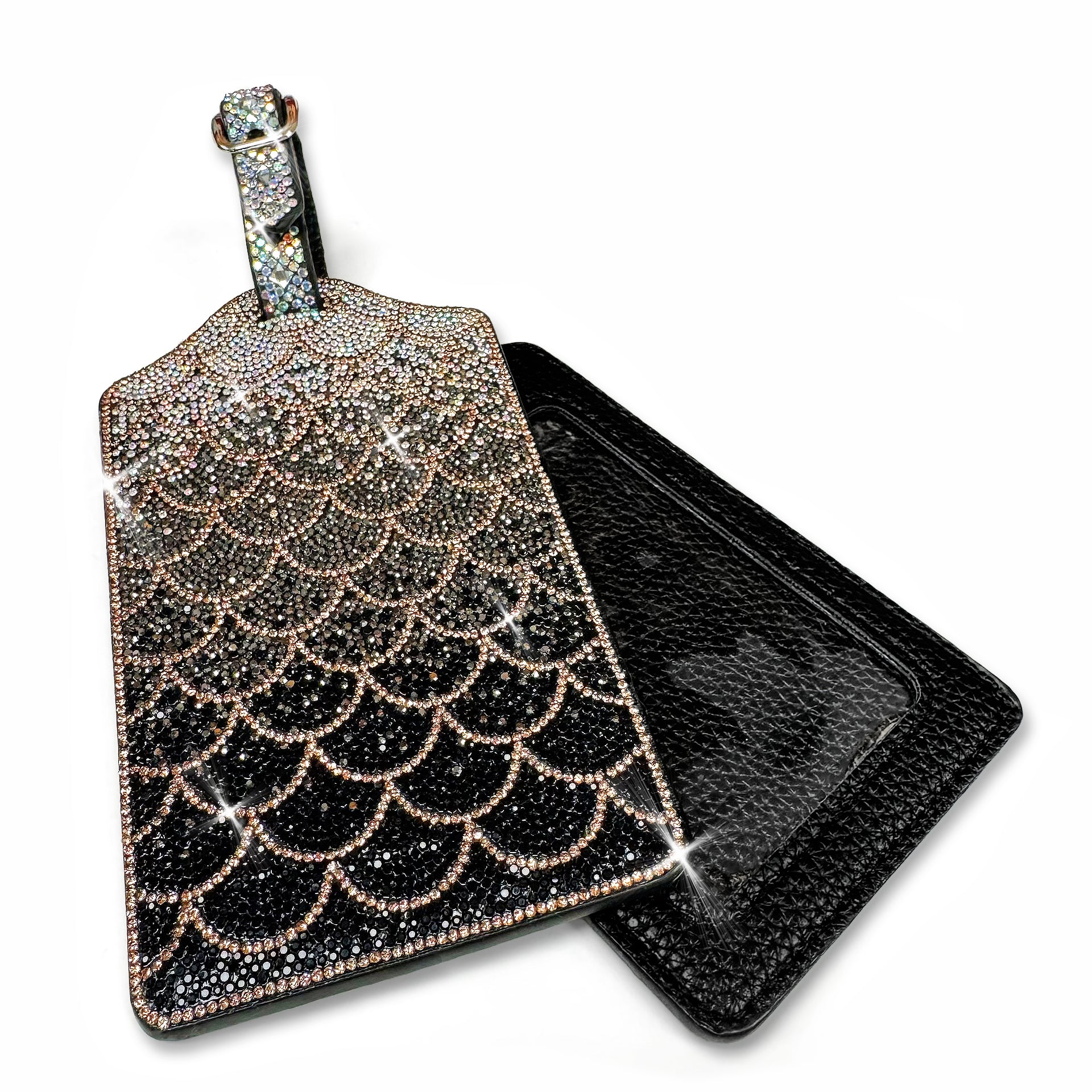 Decorative luggage tag with intricate mermaid scale design with black to silver ombre rhinestones on a white background