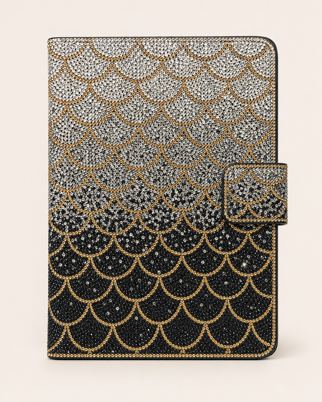 Decorative mermaid scale notebook cover with black, silver and gold pattern on a white background