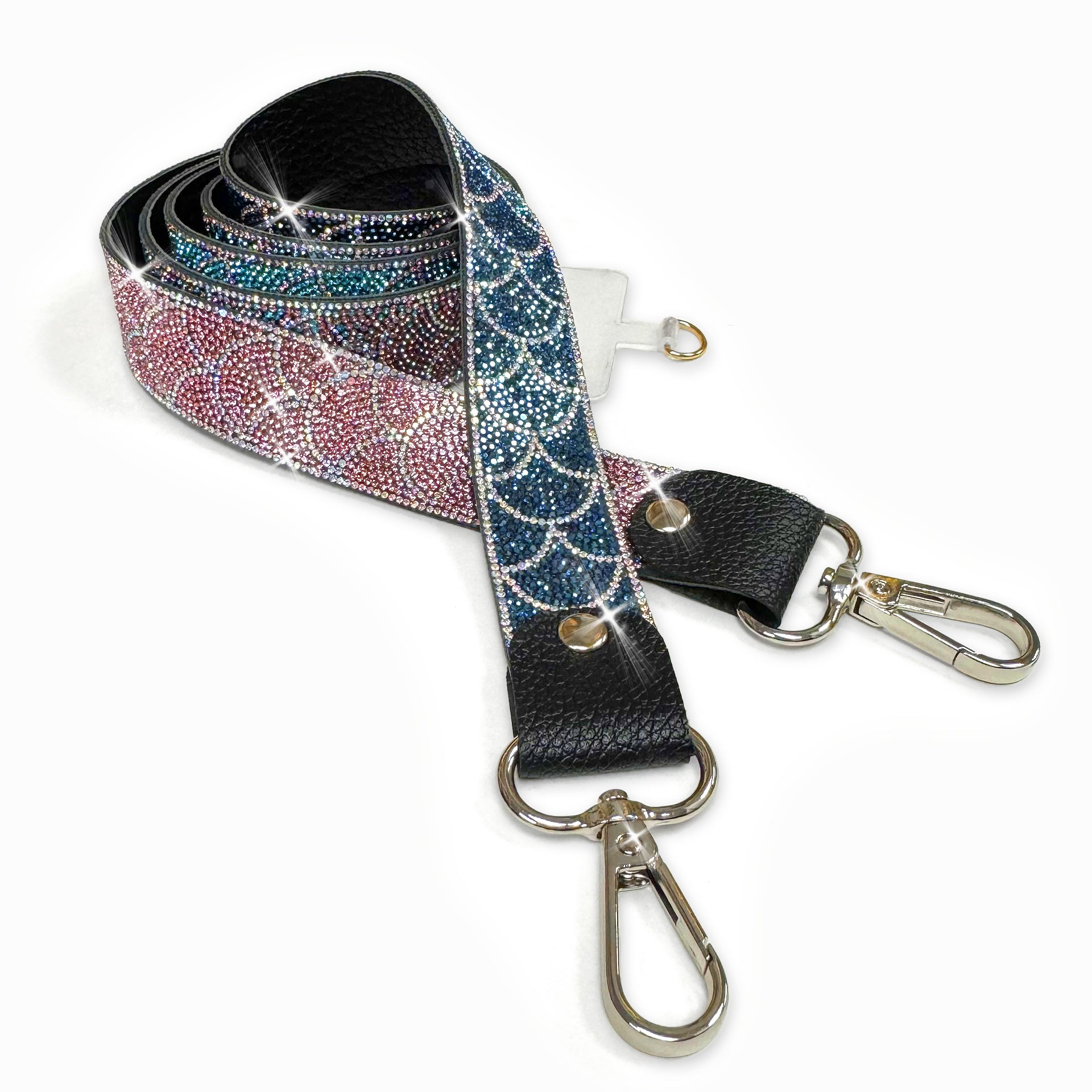 Phone lanyard in mermaid scale pattern in navy, teal glittery strap with metal clasps on a white background and pink ombre with silver details