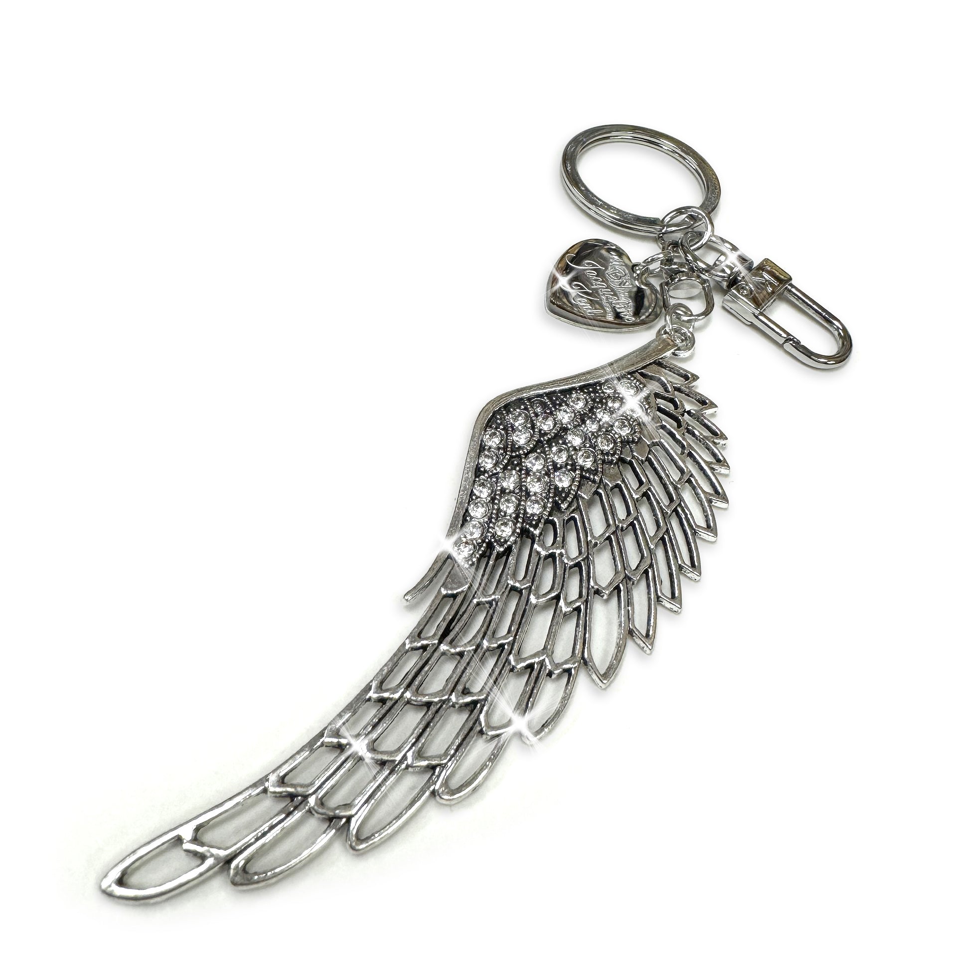 Silver angel wing purse charm with heart charm on a white background