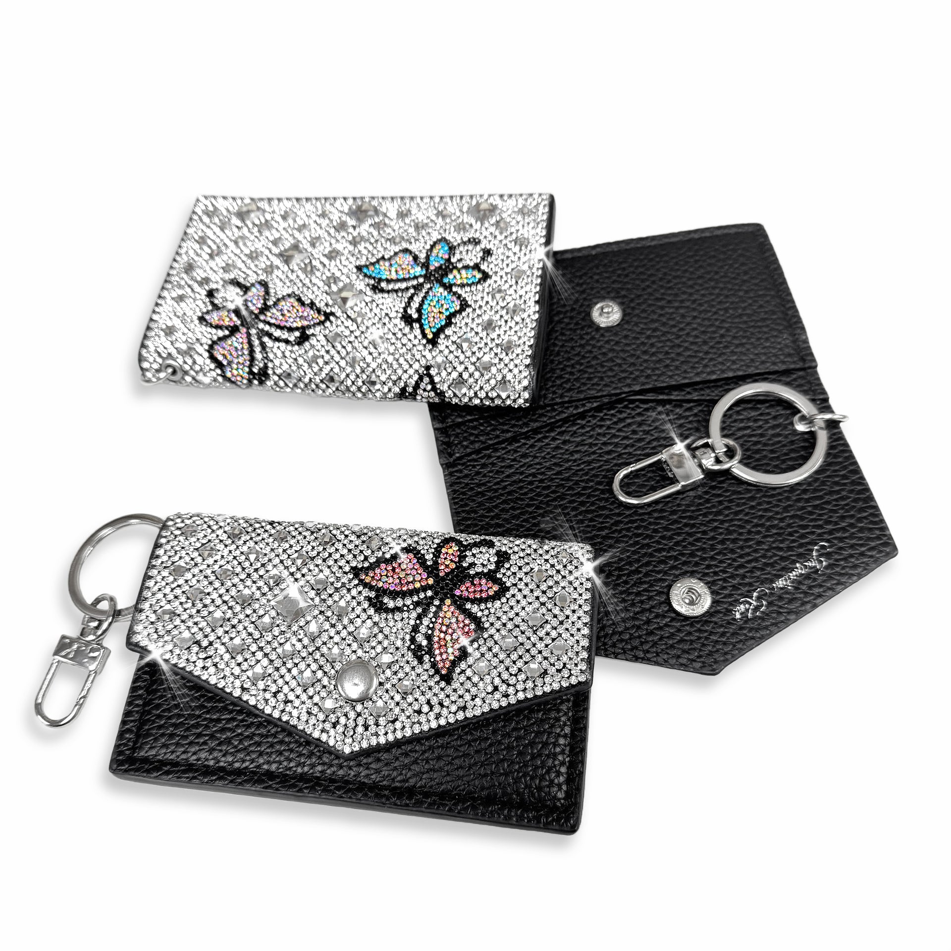 Silver and black cardholder with rhinestone butterfly designs in pink, teal and clear AB crystals with keychain on a white background.