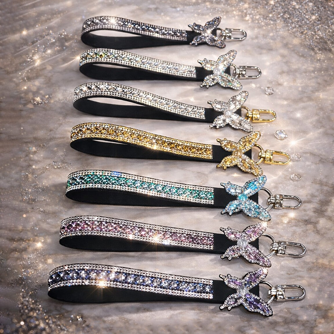 Set of decorative lanyards with crystal embellishments on a textured surface
