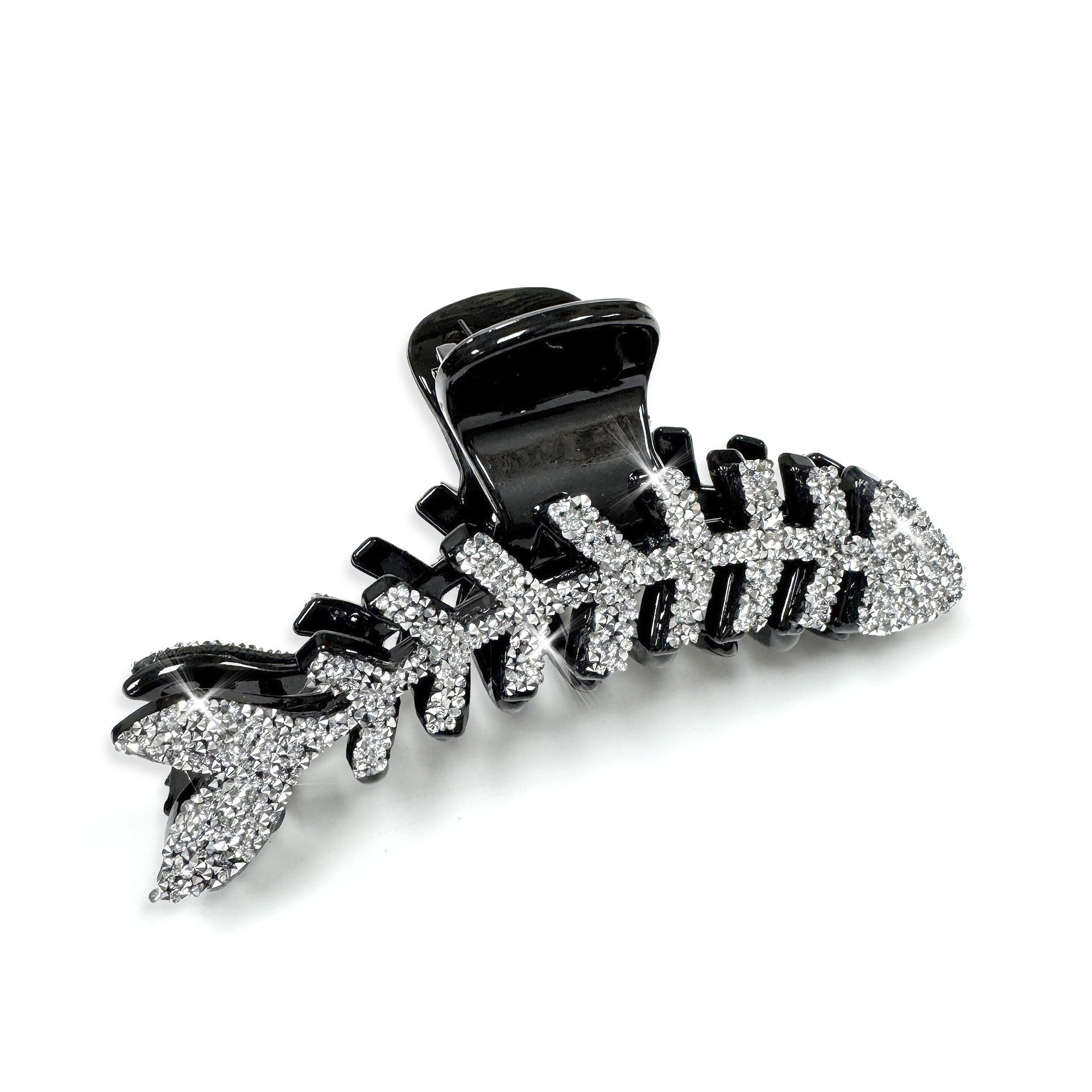 Black and silvercrystal fish bone hair clip on a white background