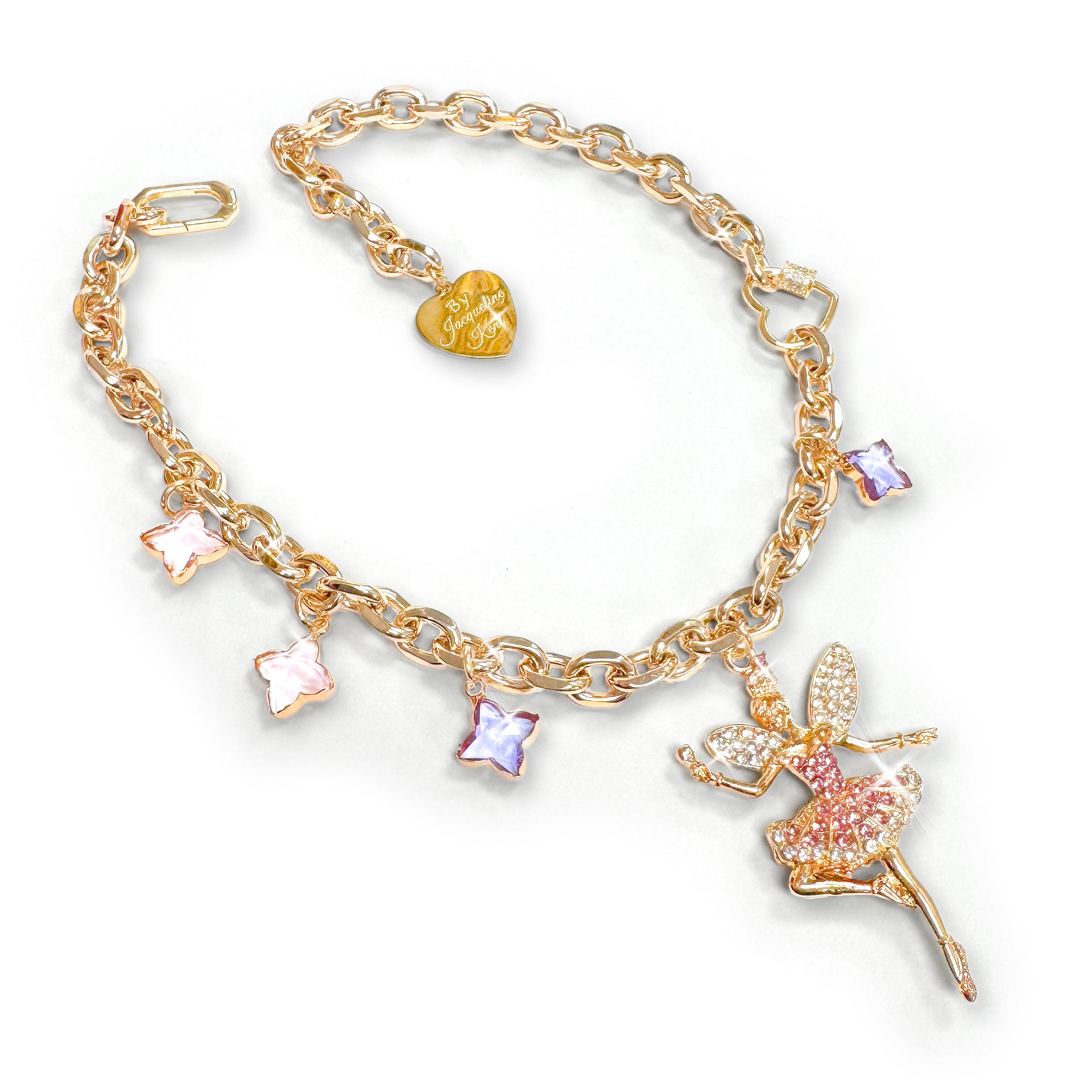 Gold 3 in 1 necklace with sugar plum fairy charm encrusted with clear and pink rhinestones, enamelled charms and heart shaped ‘Jacqueline Kent' branded tag featuring the brand 