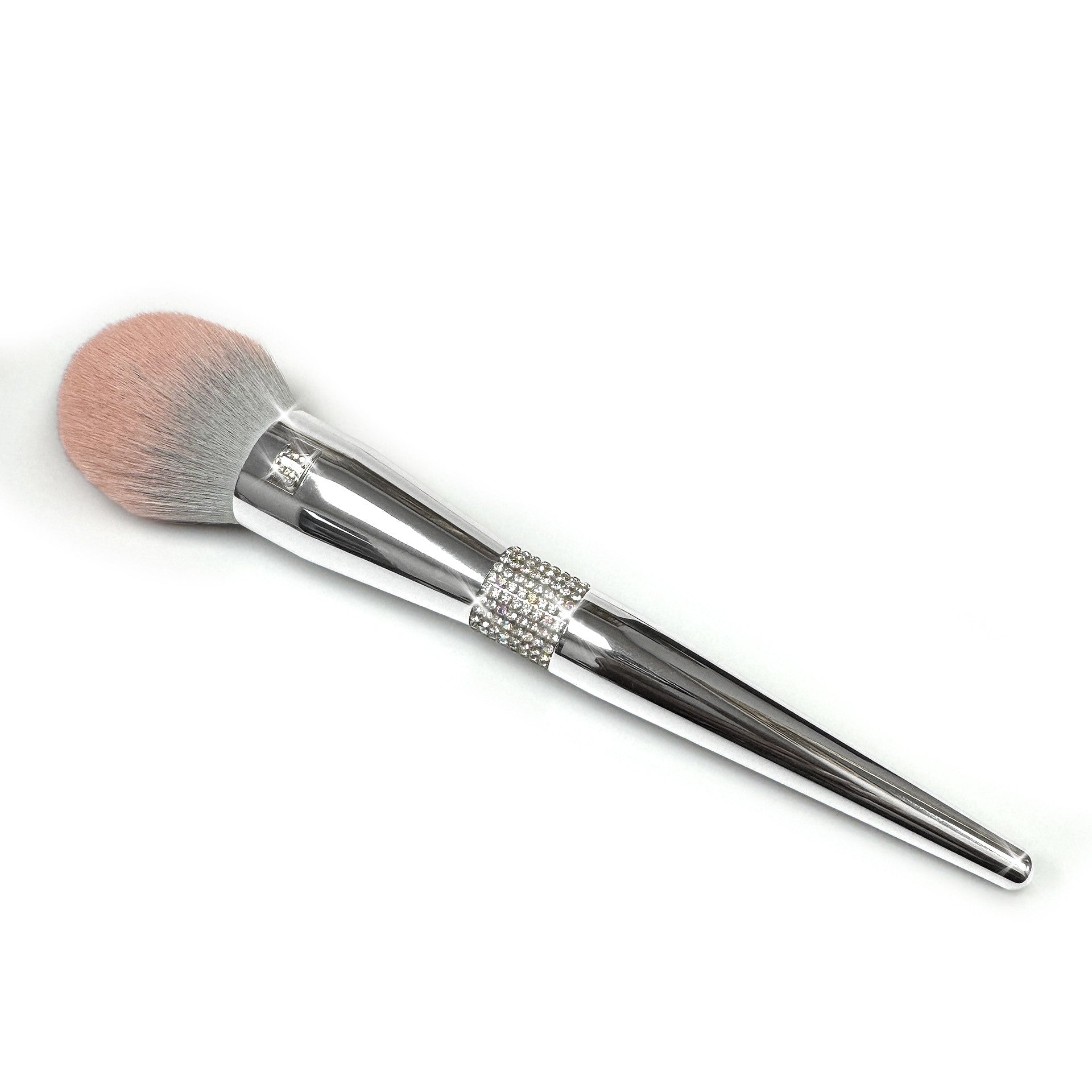 Makeup brush with decorative rhinestone embellished silver handle and pink bristle head on a white background