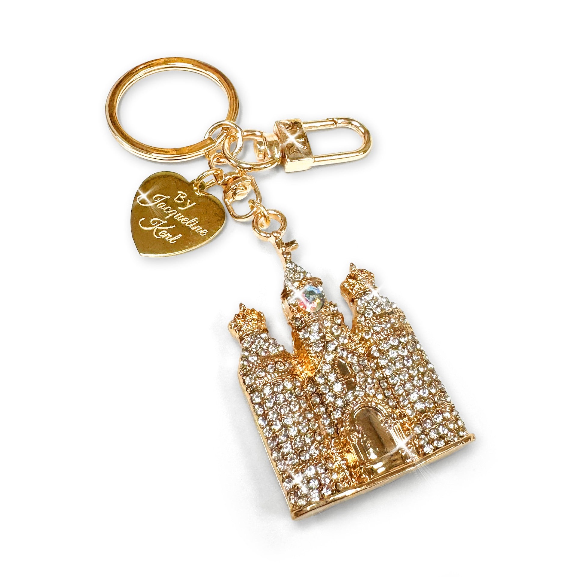Gold keychain with castle design and heart-shaped Jacqueline Kent branded tag on a white background