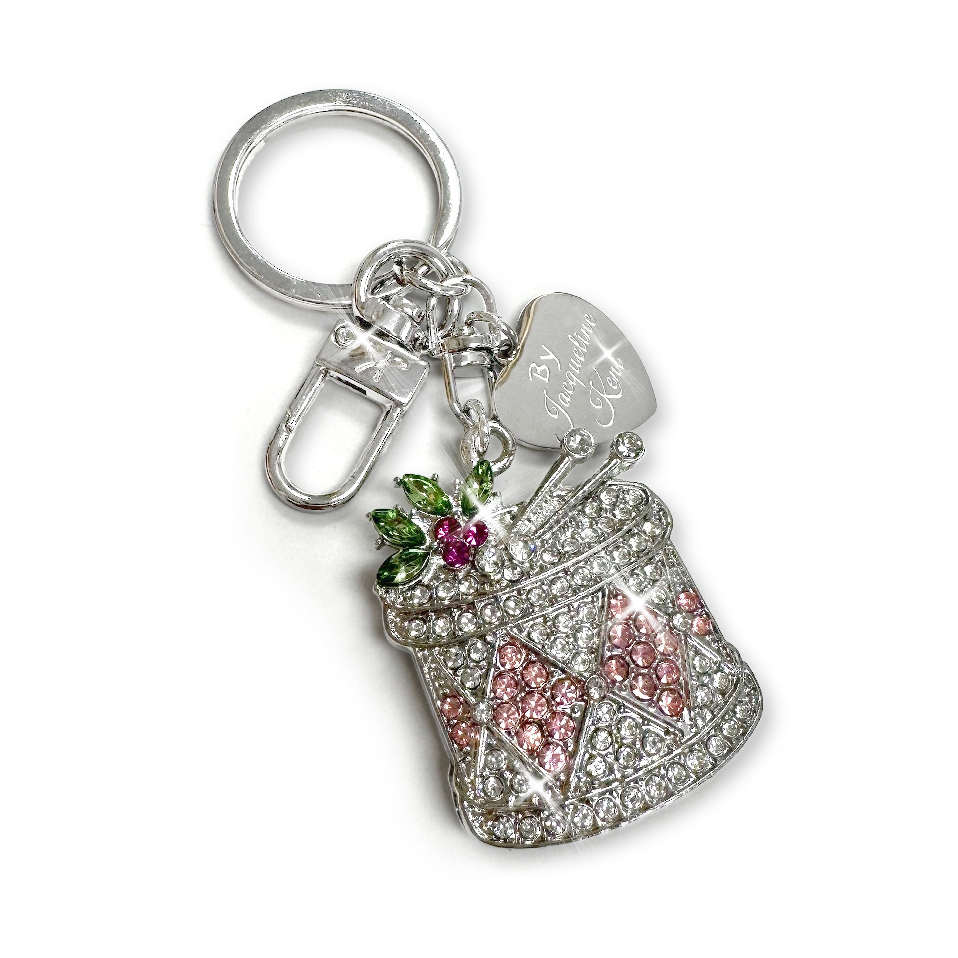 Silver drum purse charm/keychain in pink, clear, red and green rhinestone details with a ‘Jacqueline Kent’ branded heart tag on a white background