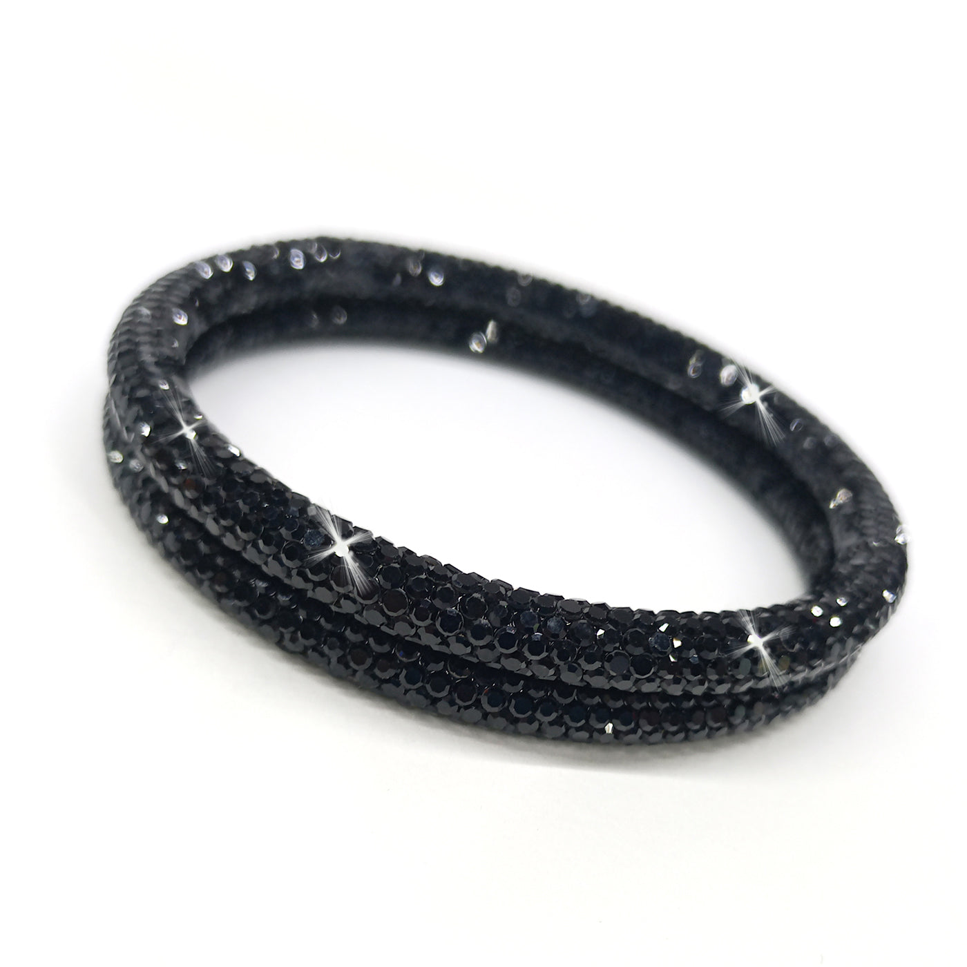 Black rhinestone bangle bracelets on a white background