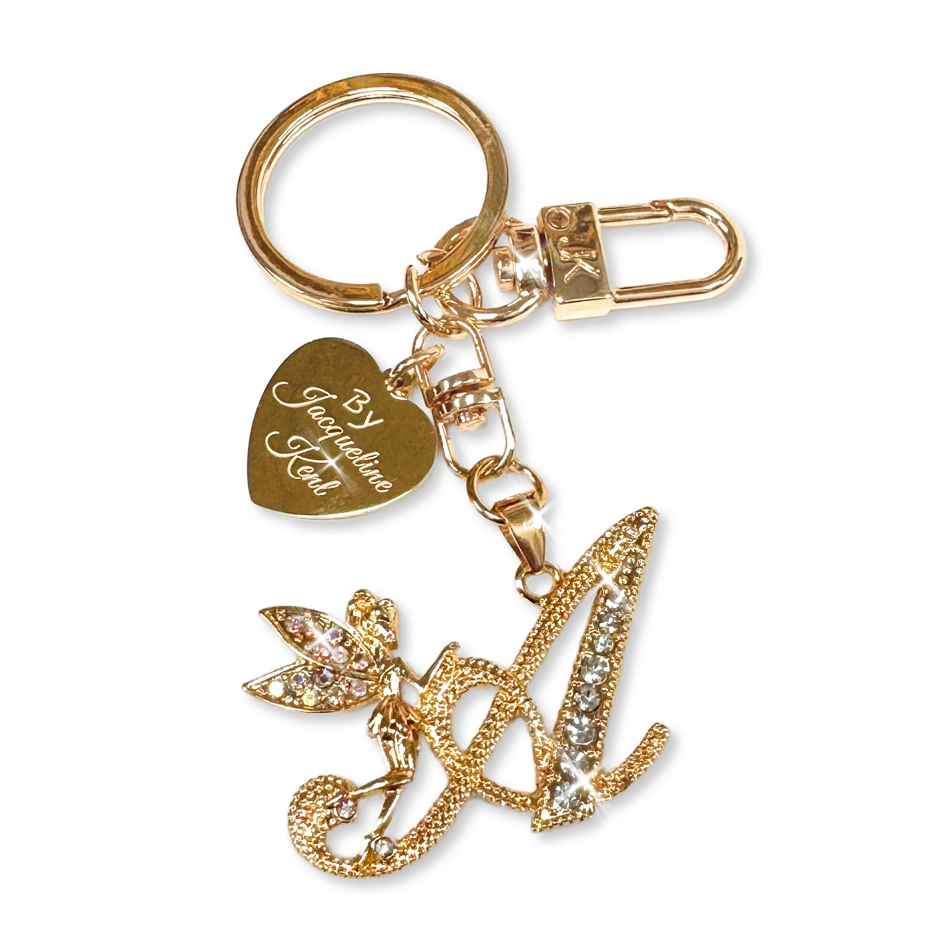 Gold and crystal embellished keychain with decorative letter 'A' and heart-shaped Jacqueline Kent branded tag on a white background