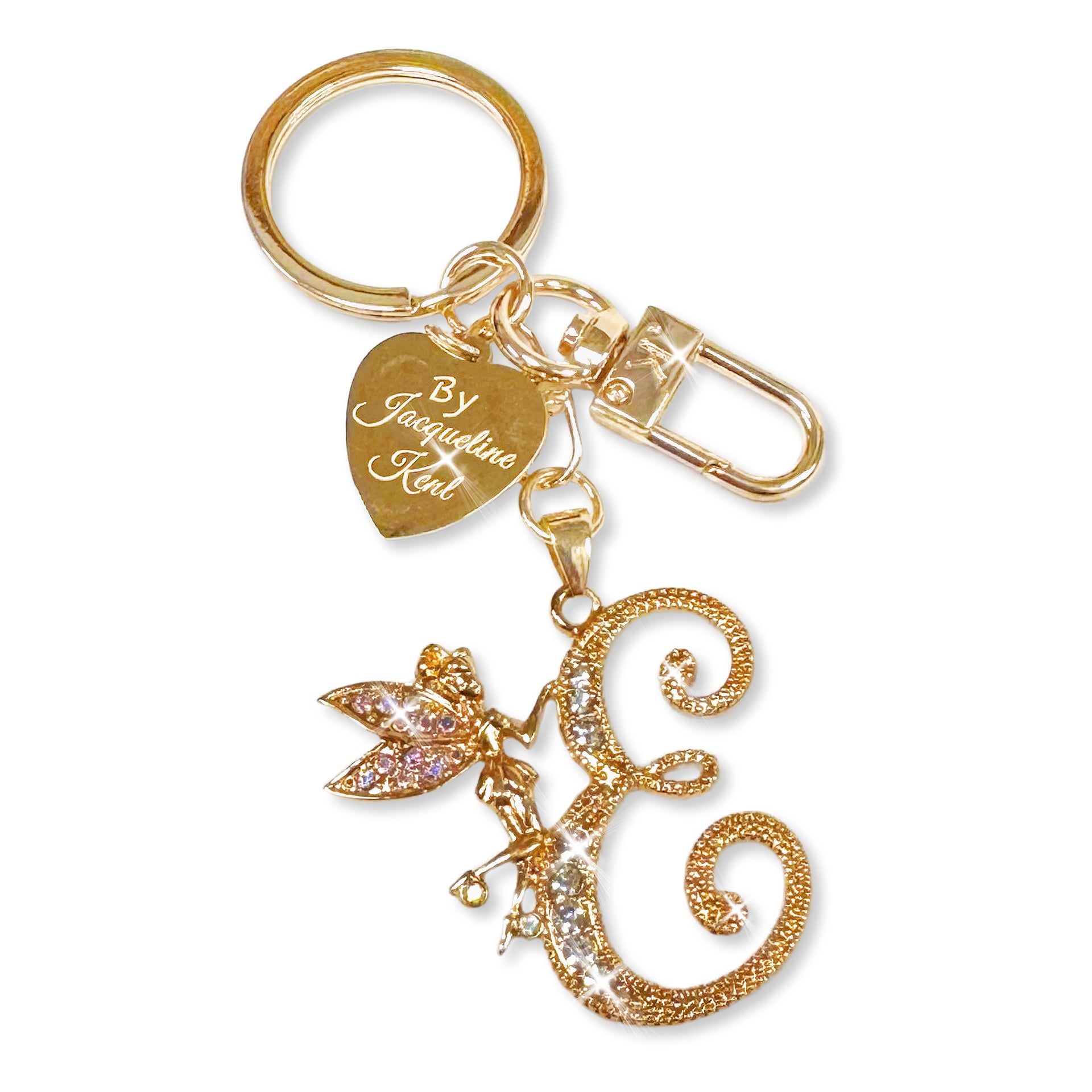 Gold and crystal embellished keychain with decorative letter 'E' and heart-shaped Jacqueline Kent branded tag on a white background