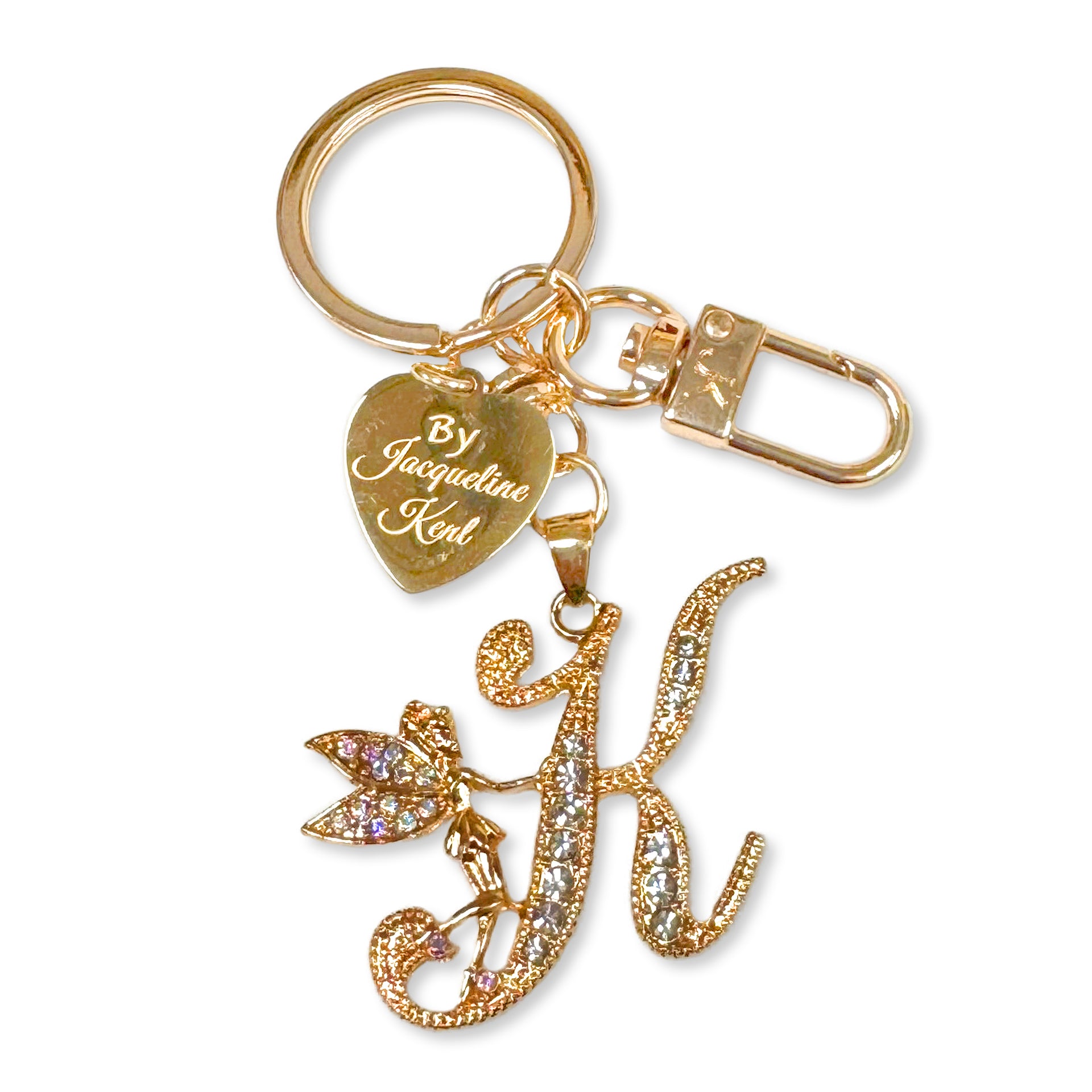 Gold and crystal embellished keychain with decorative letter 'K and heart-shaped Jacqueline Kent branded tag on a white background