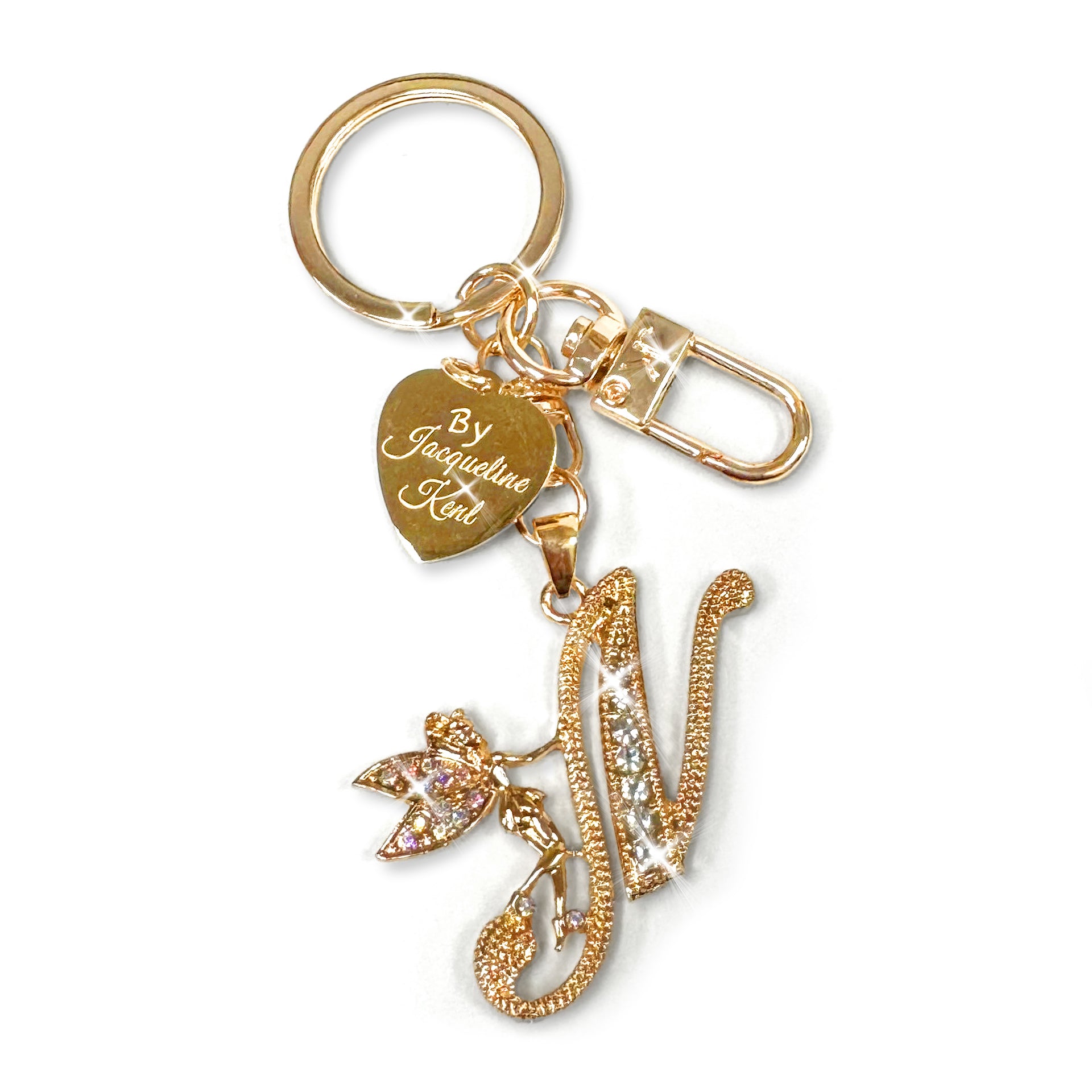 Gold and crystal embellished keychain with decorative letter 'N' and heart-shaped Jacqueline Kent branded tag on a white background