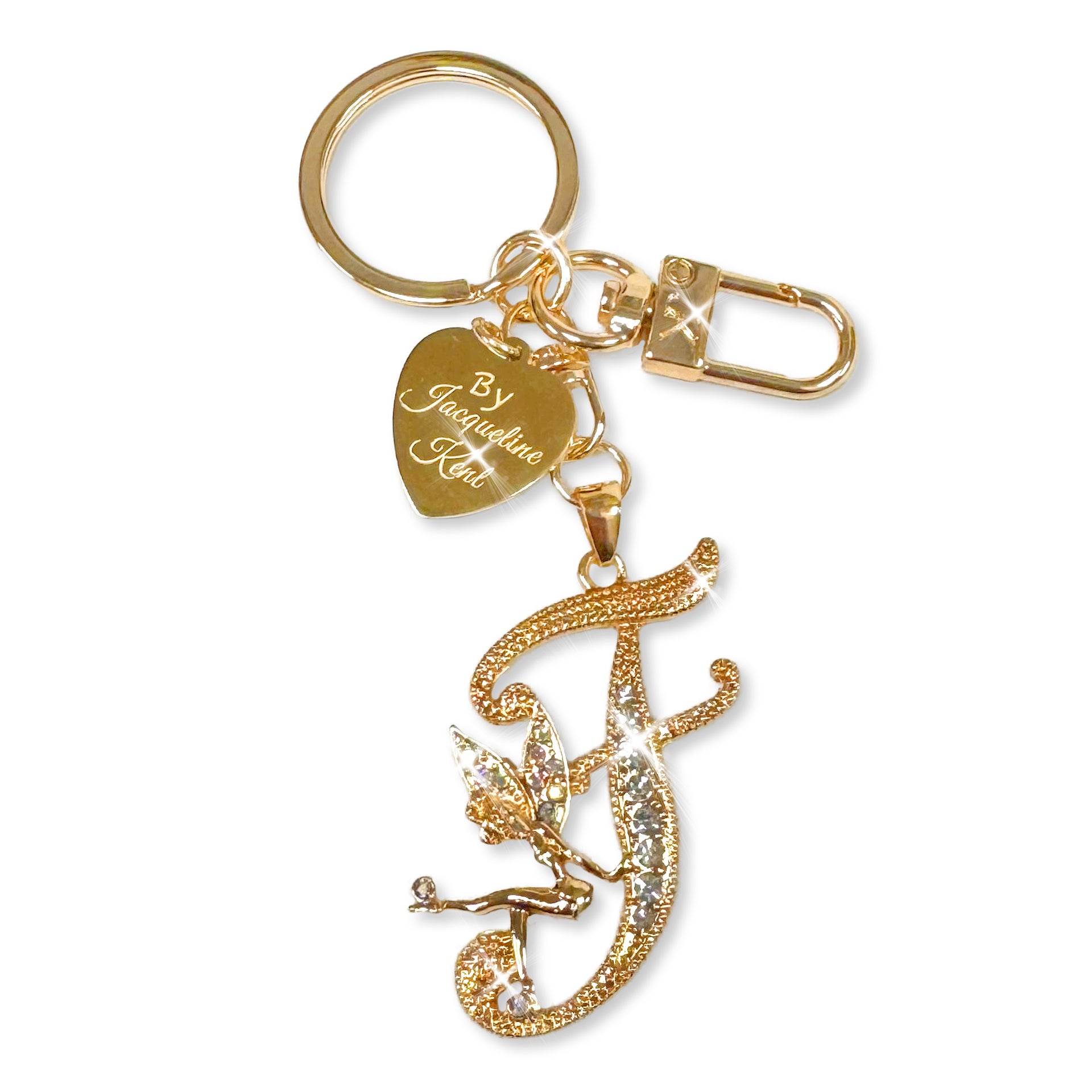 Gold and crystal embellished keychain with decorative letter 'F' and heart-shaped Jacqueline Kent branded tag on a white background