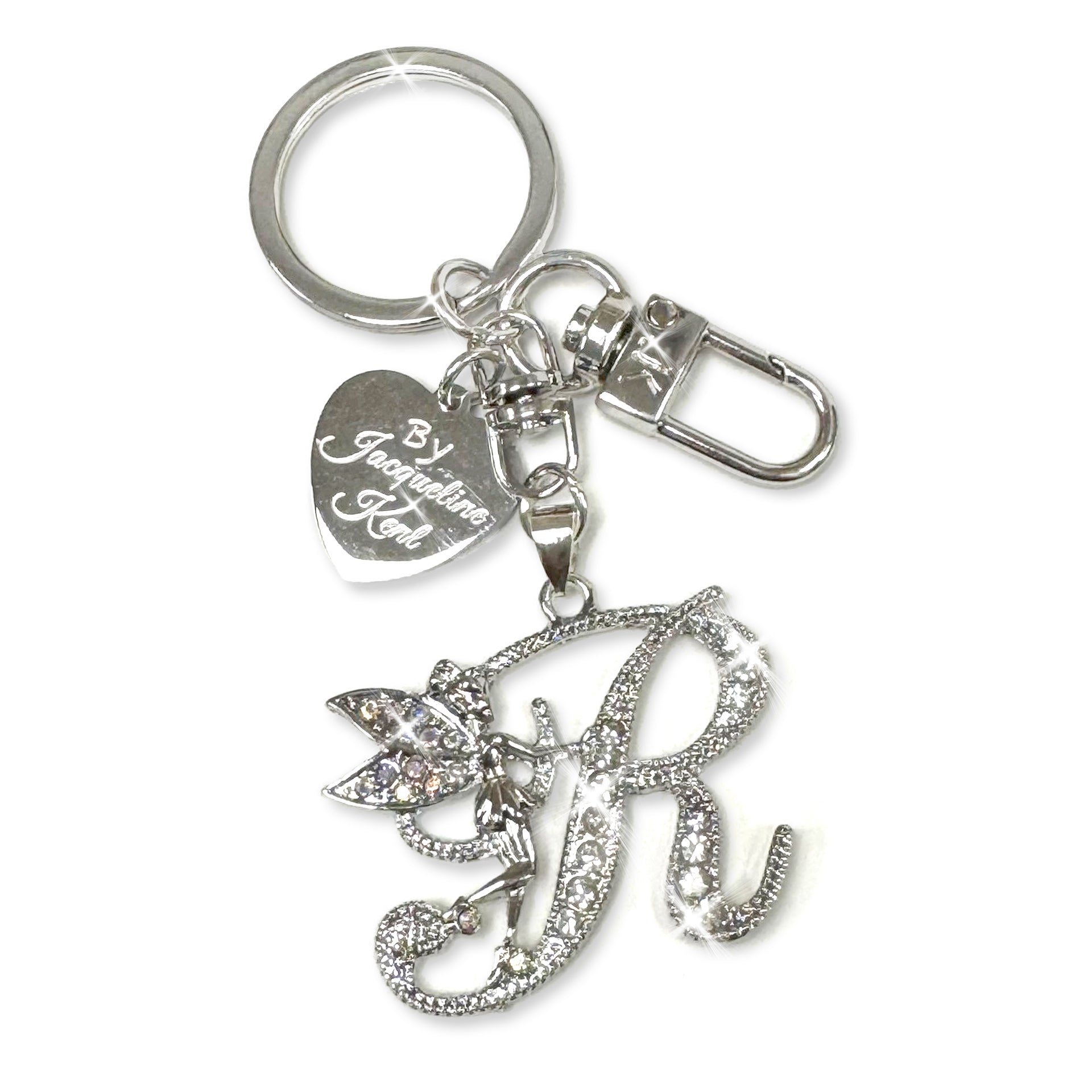 Silver and crystal embellished keychain with decorative letter 'R' and heart-shaped Jacqueline Kent branded tag on a white background