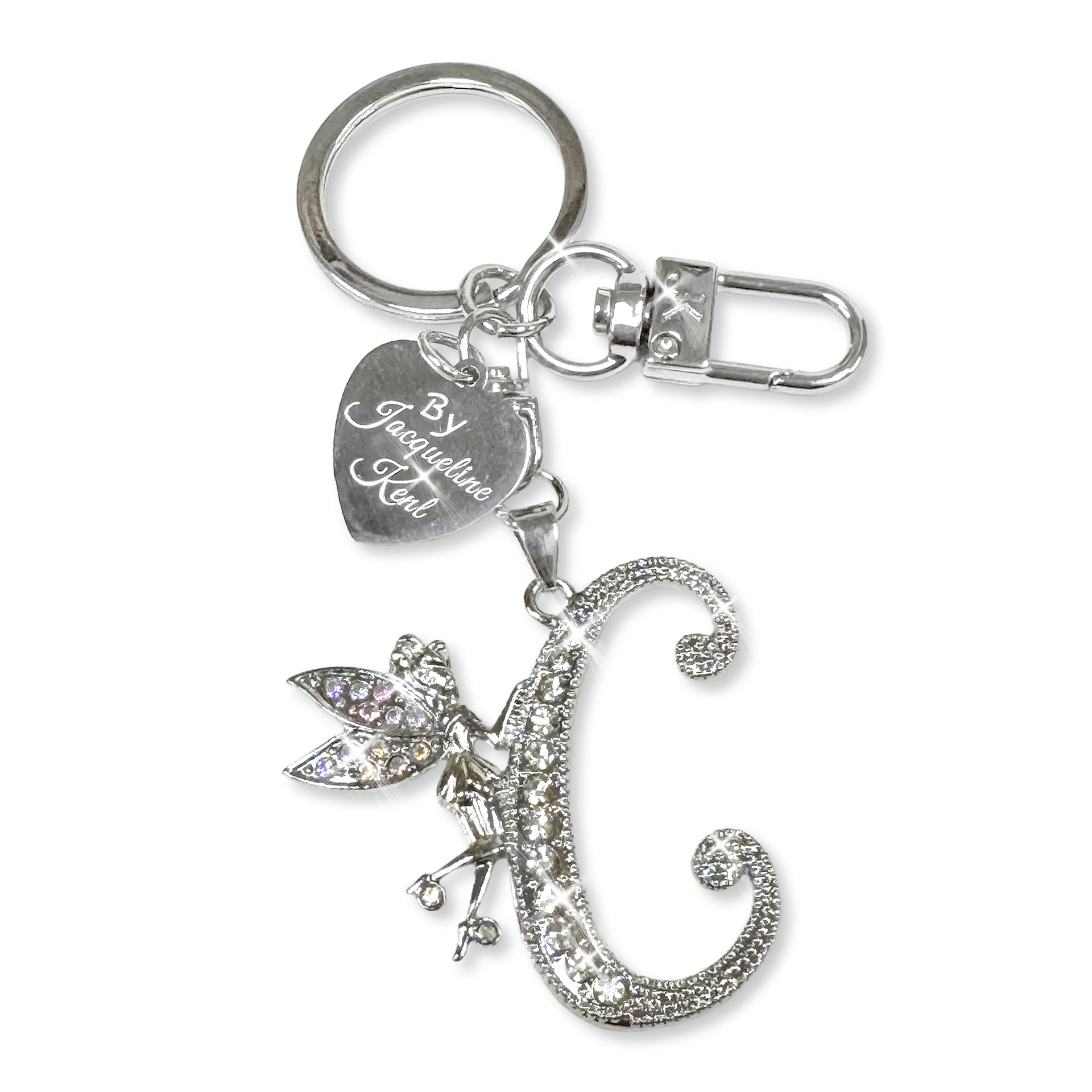 Silver and crystal embellished keychain with decorative letter 'C' and heart-shaped Jacqueline Kent branded tag on a white background