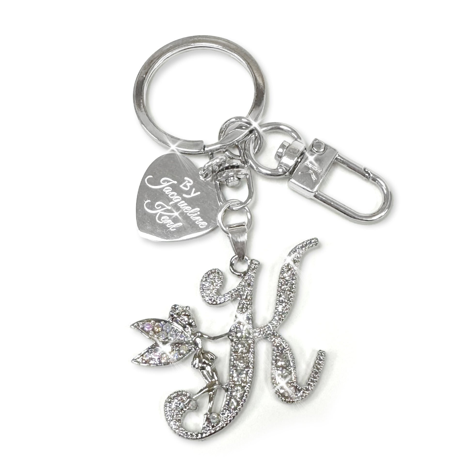 Silver and crystal embellished keychain with decorative letter 'K' and heart-shaped Jacqueline Kent branded tag on a white background