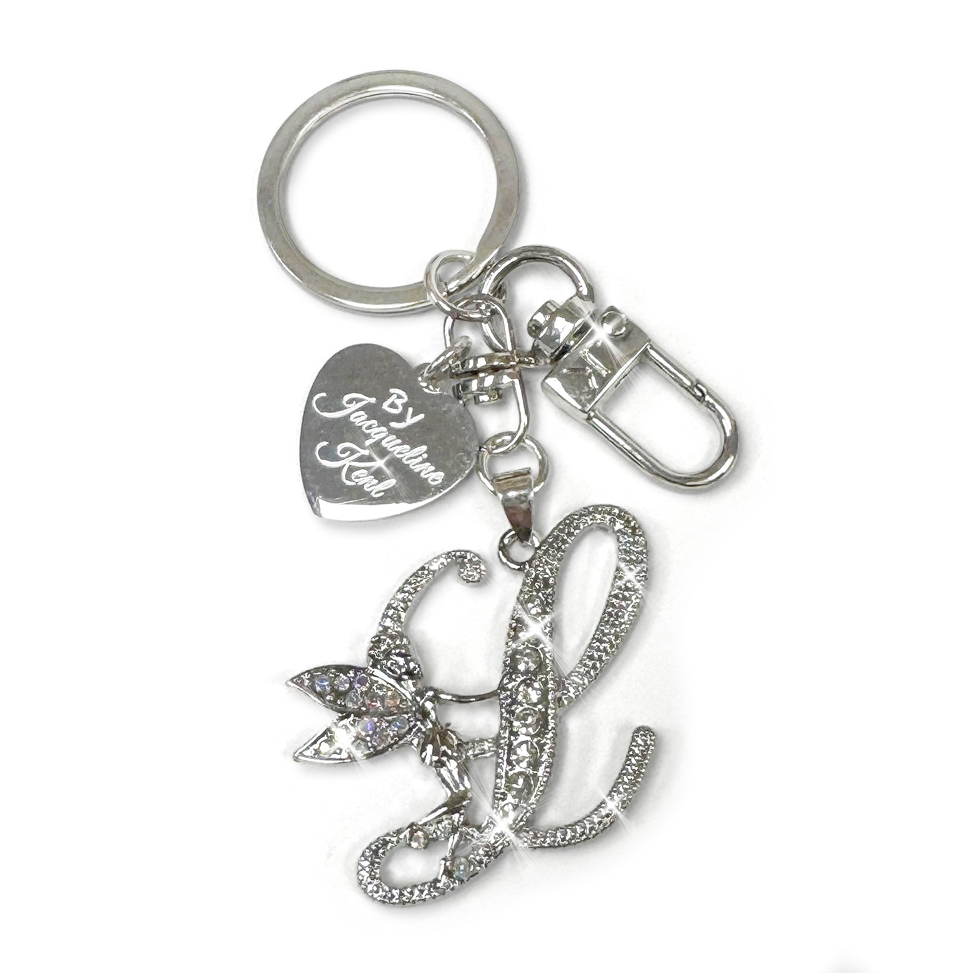 Silver and crystal embellished keychain with decorative letter 'L' and heart-shaped Jacqueline Kent branded tag on a white background