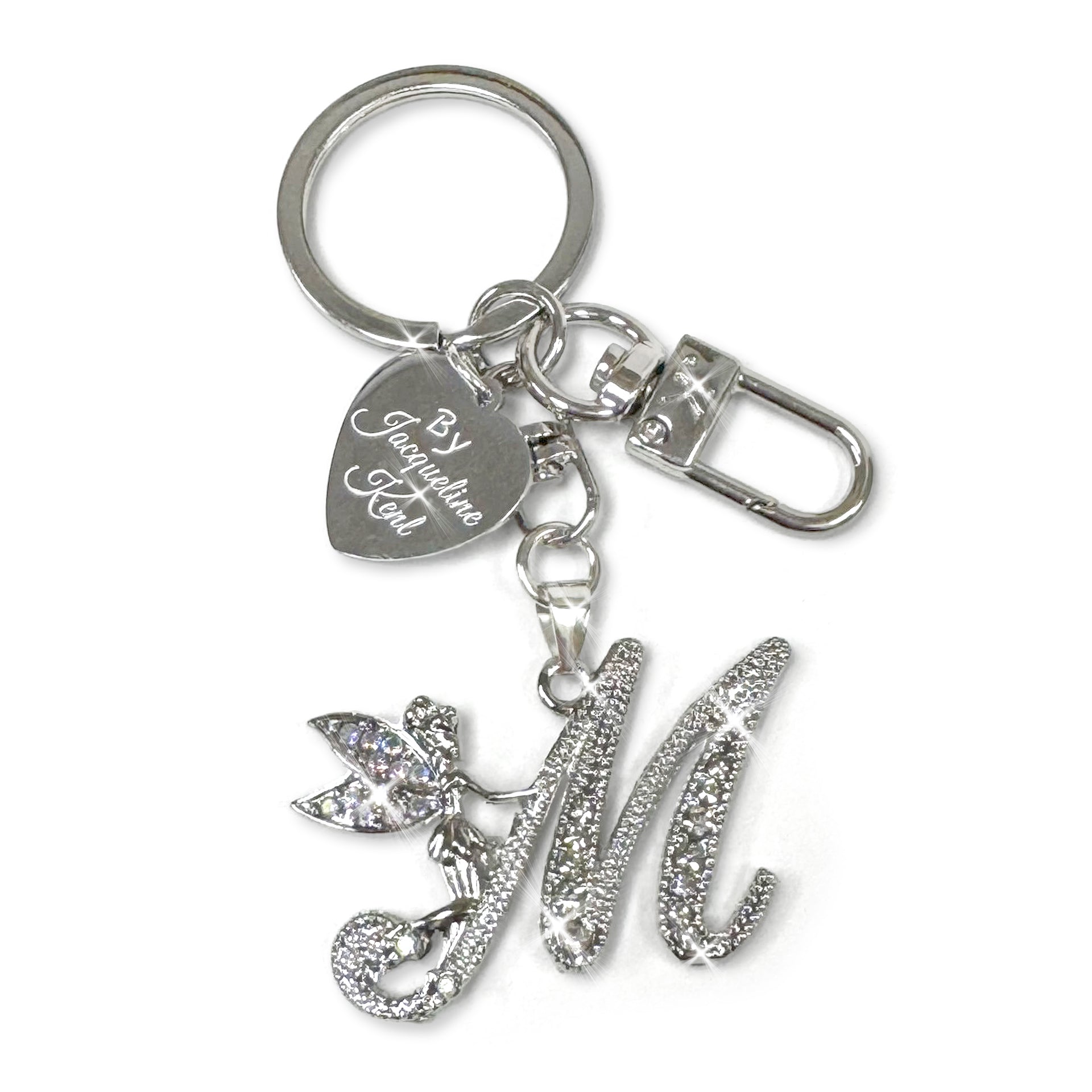 Silver and crystal embellished keychain with decorative letter 'M' and heart-shaped Jacqueline Kent branded tag on a white background