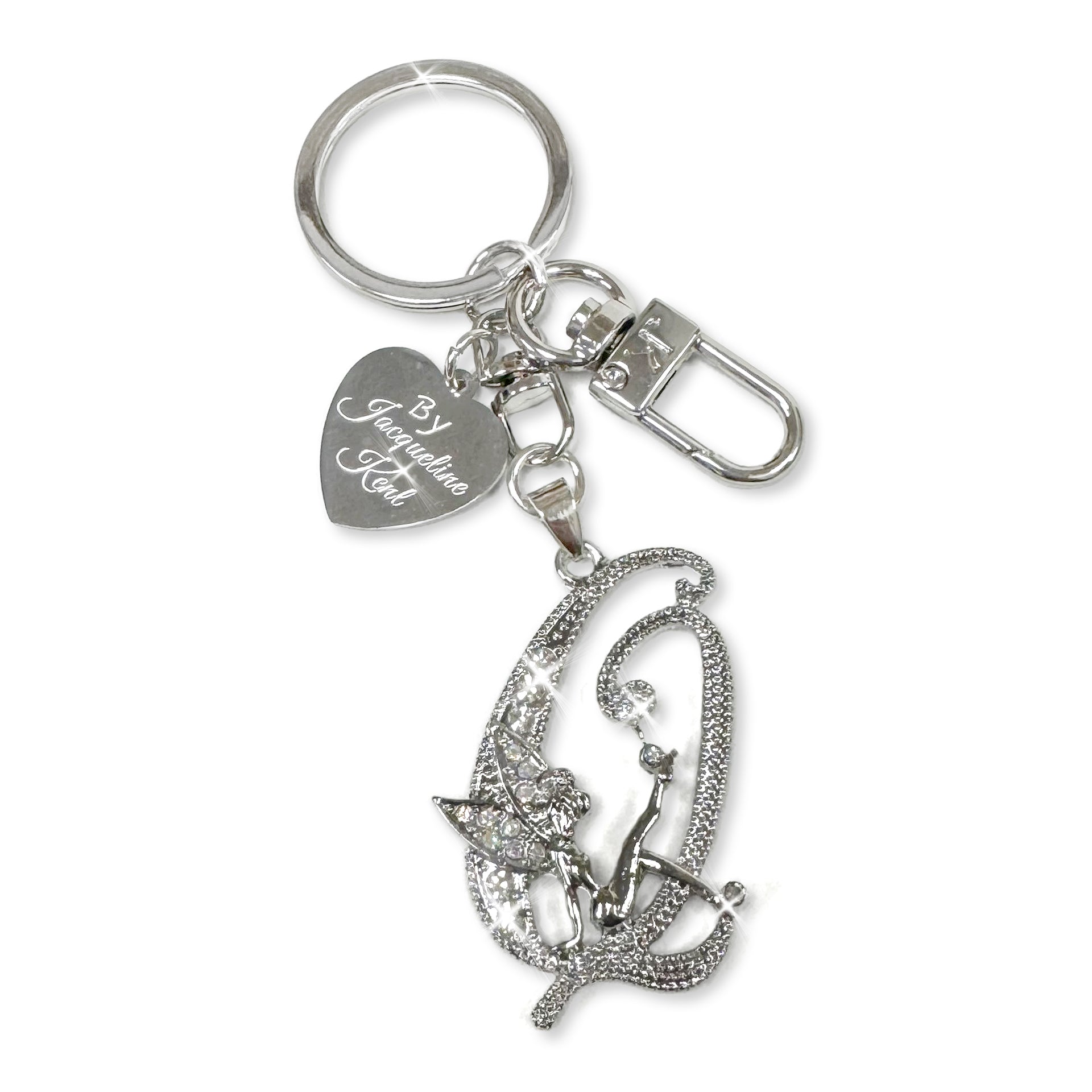 Silver and crystal embellished keychain with decorative letter 'X' and heart-shaped Jacqueline Kent branded tag on a white background