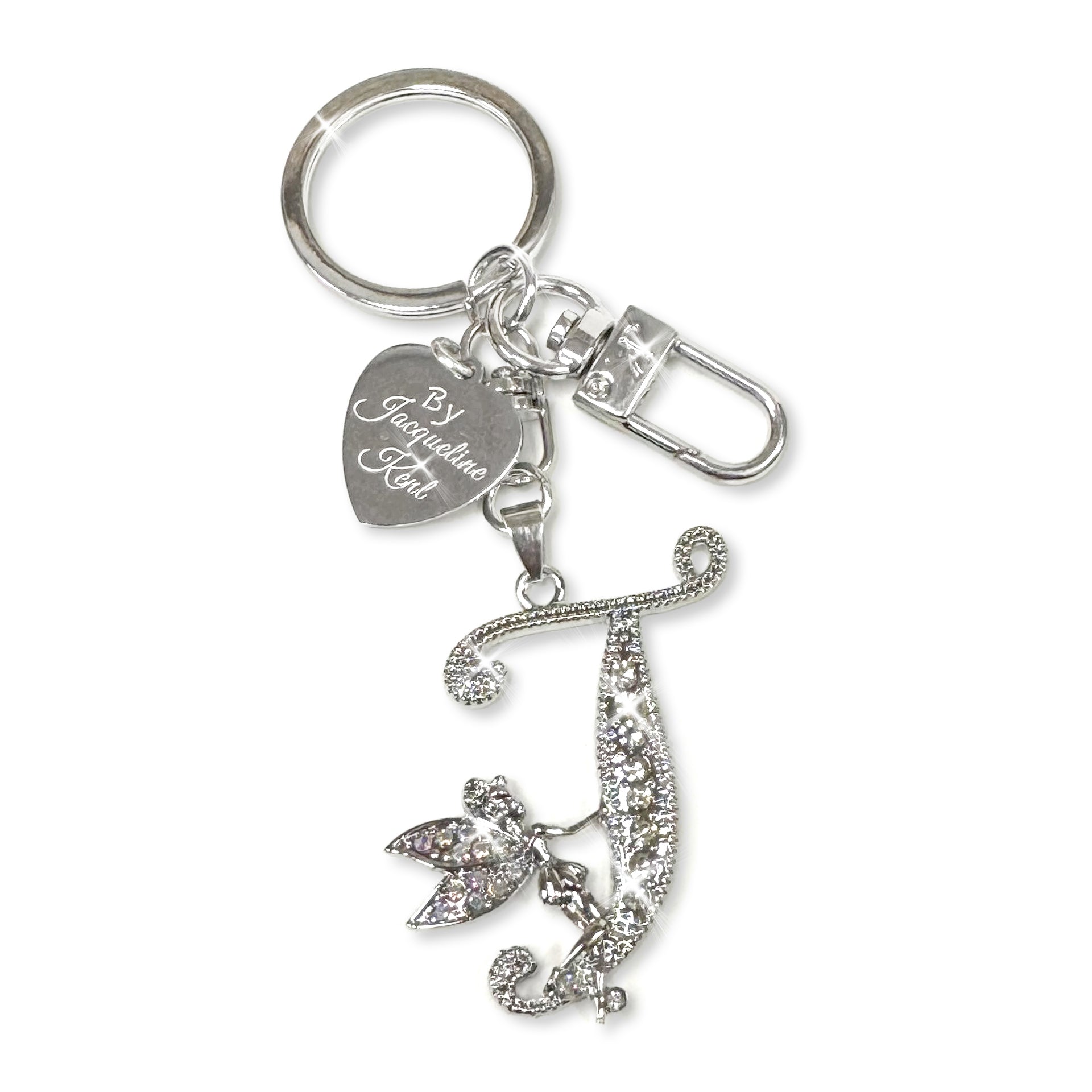 Silver and crystal embellished keychain with decorative letter 'T' and heart-shaped Jacqueline Kent branded tag on a white background