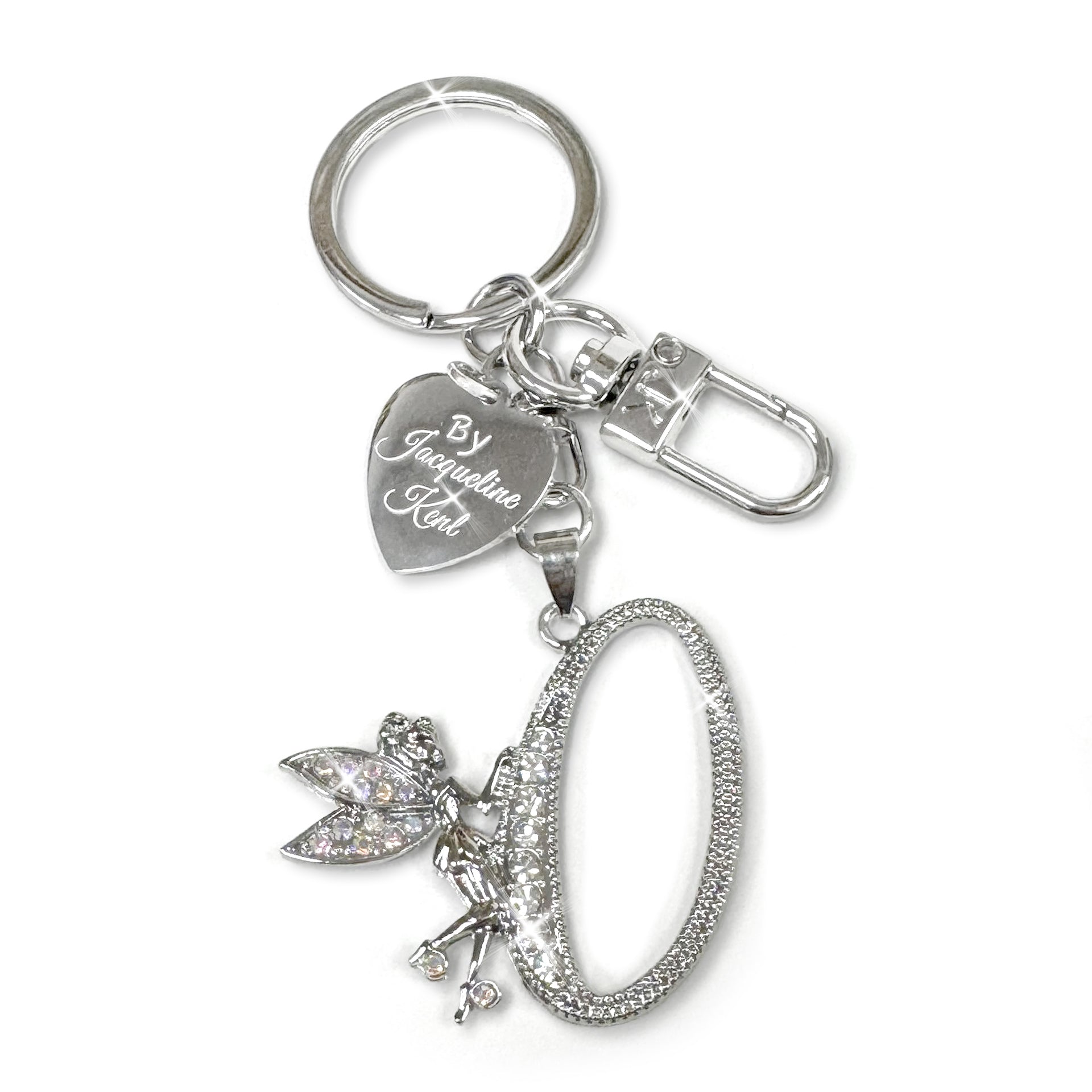 Silver and crystal embellished keychain with decorative letter 'O' and heart-shaped Jacqueline Kent branded tag on a white background