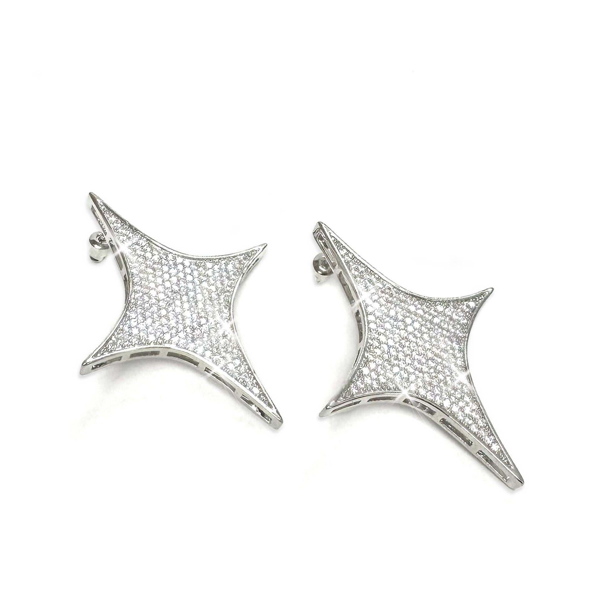Pair of star-shaped silver earrings with rhinestones on a white background
