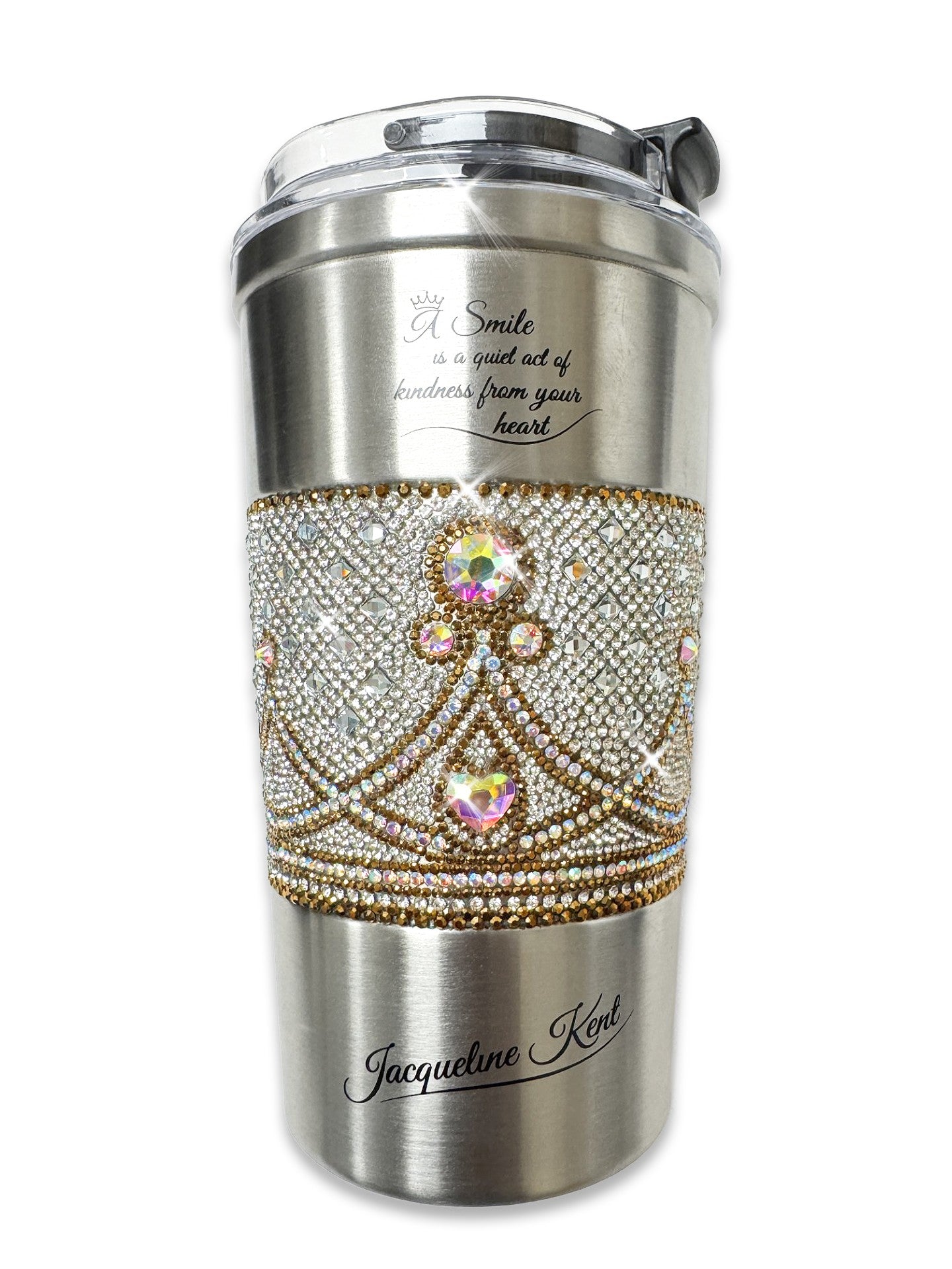 Jacqueline Kent insulated coffee cup embellished with silver, gild and ab crystal crown design, inspirational message on up says "A smile is a quiet act of kindness from your heart". Jacqueline Kent signature on bottom of cup.