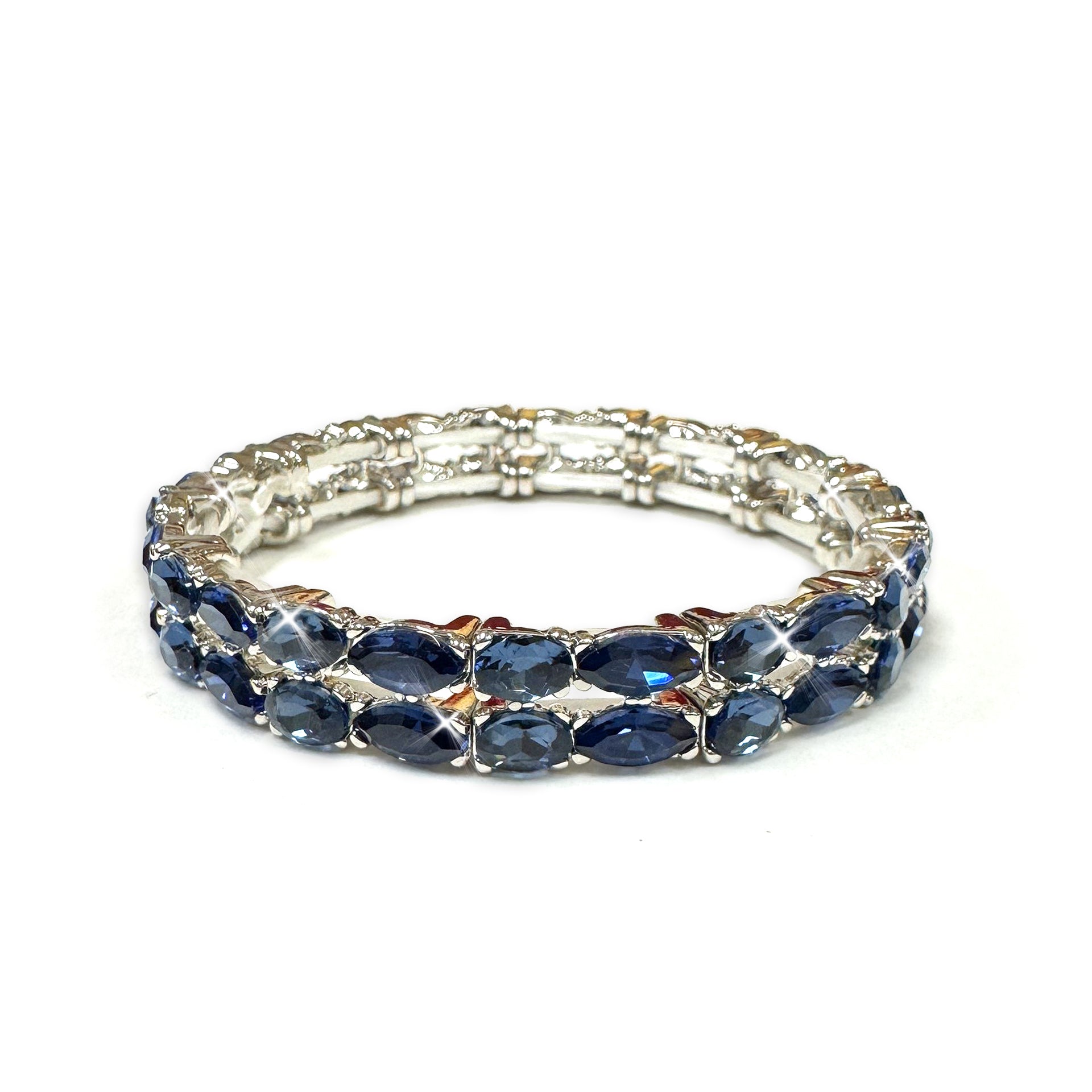 Silver bracelet with blue crystals on a white background