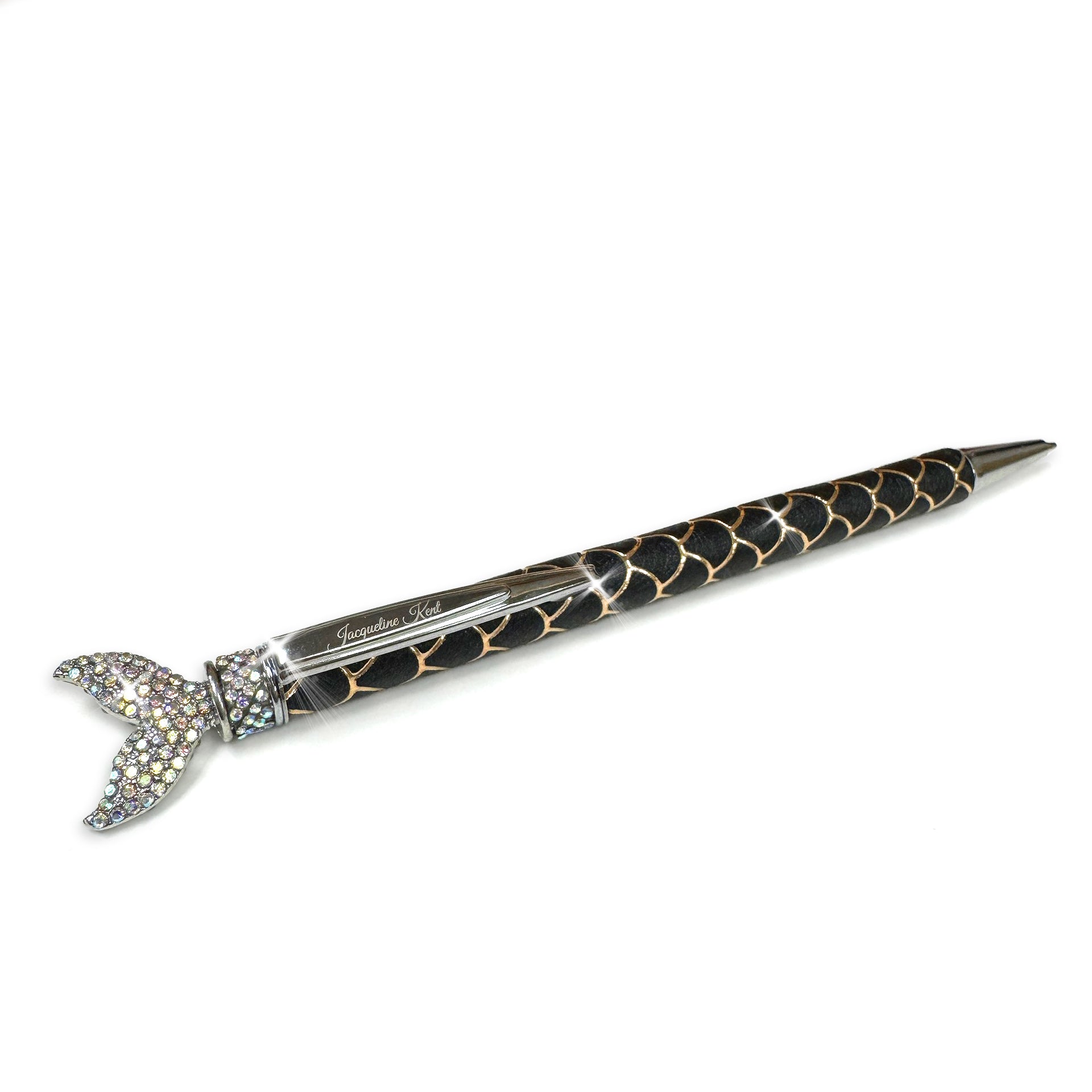 Decorative mermaid scale pen with black and gold pattern and mermaid tail with clear crystals on a white background