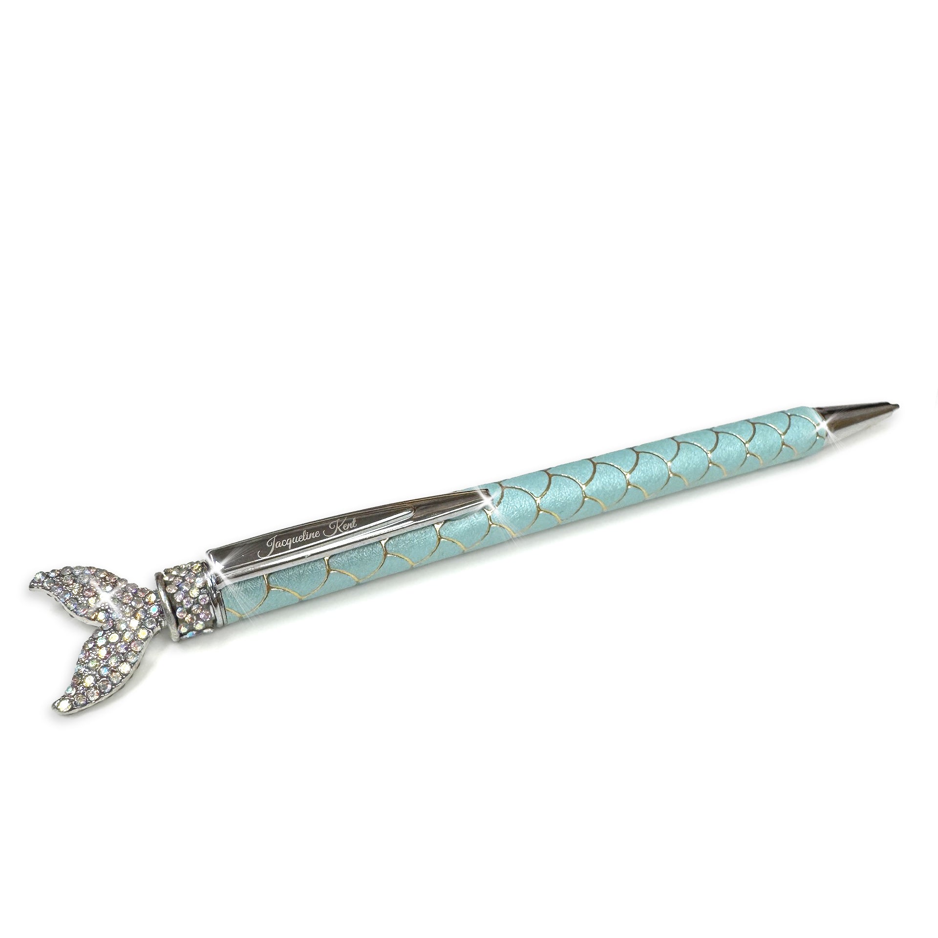 Decorative mermaid pen with turquoise body and gold and silver accents with embellished mermaid tail top on a white background