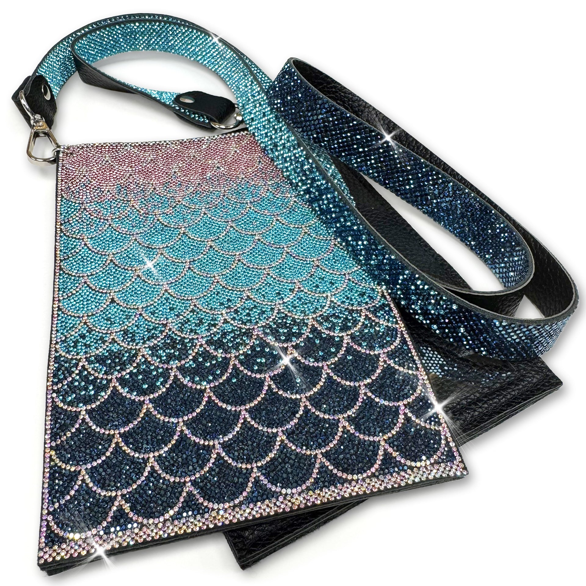 Mermaid scale patterned cell phone pouch in navy, turquoise and pink rhinestones with silver crystal details with a strap on a white background