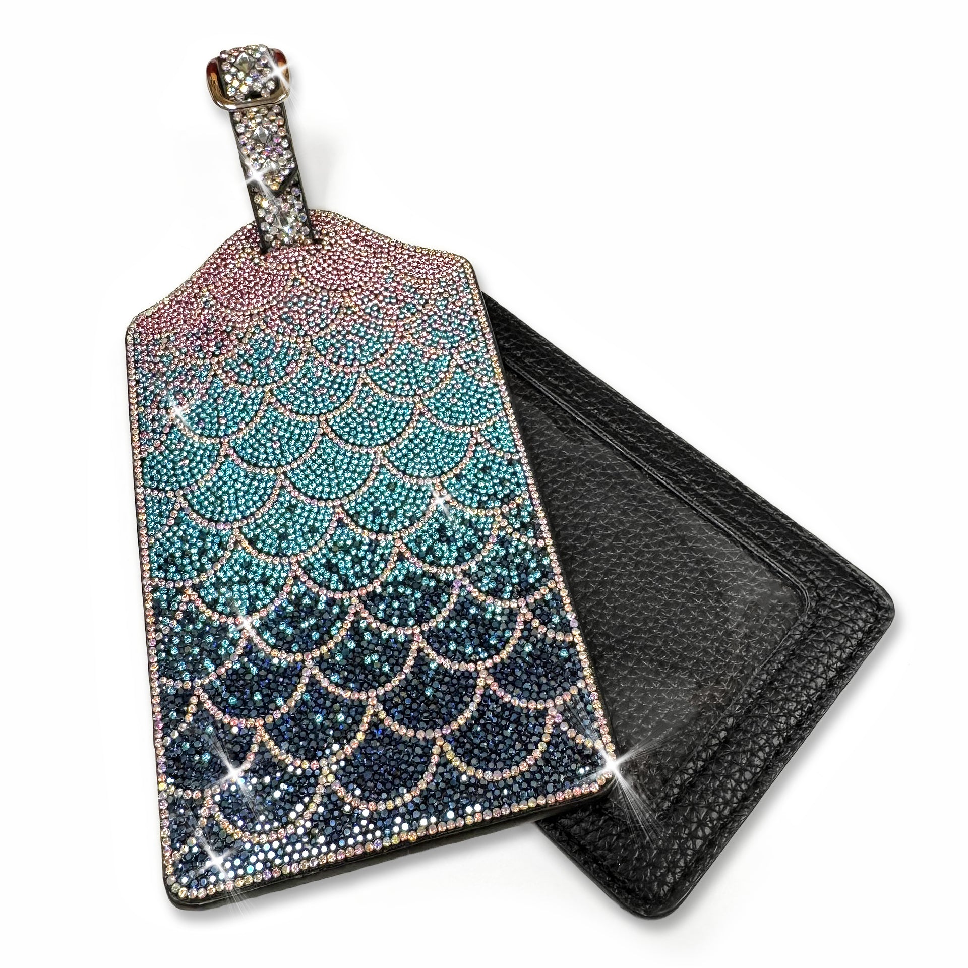 Mermaid scale patterned luggage tag with rhinestones in black, teal, pink and gold on a white background