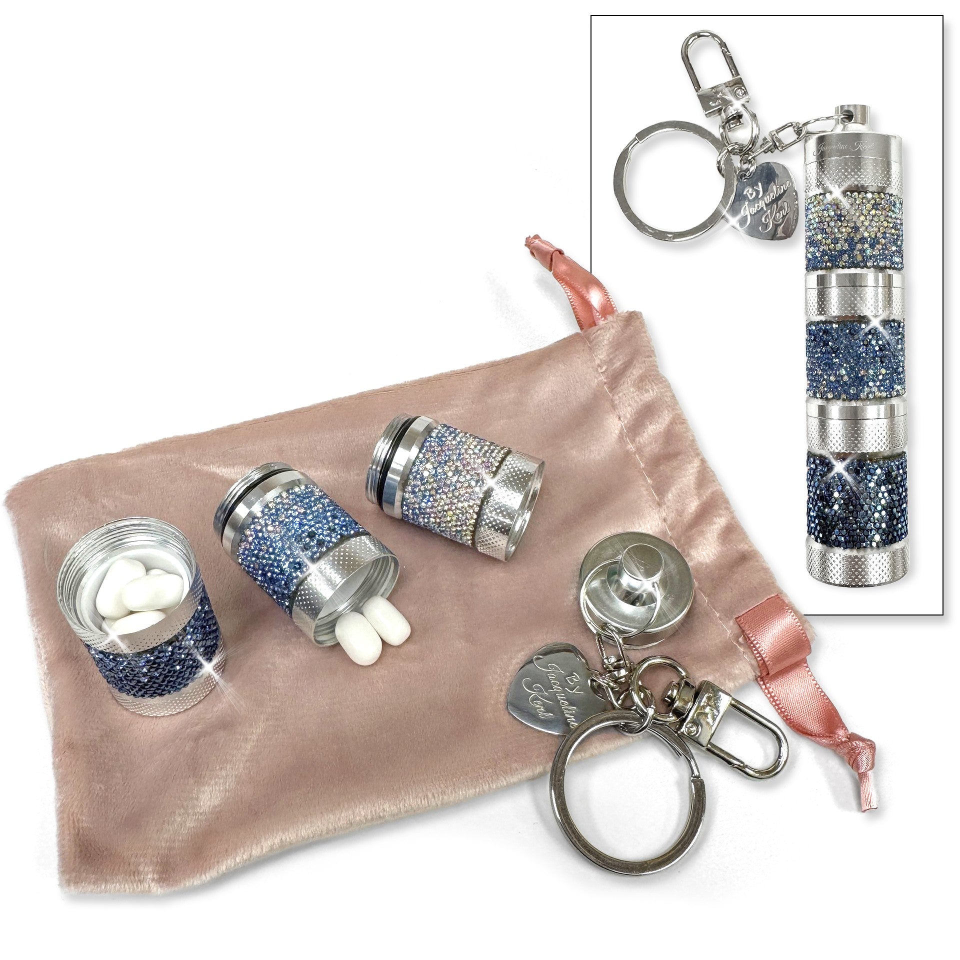 Silver and blue decorative pill containers with keychains on a pink fabric pouch.