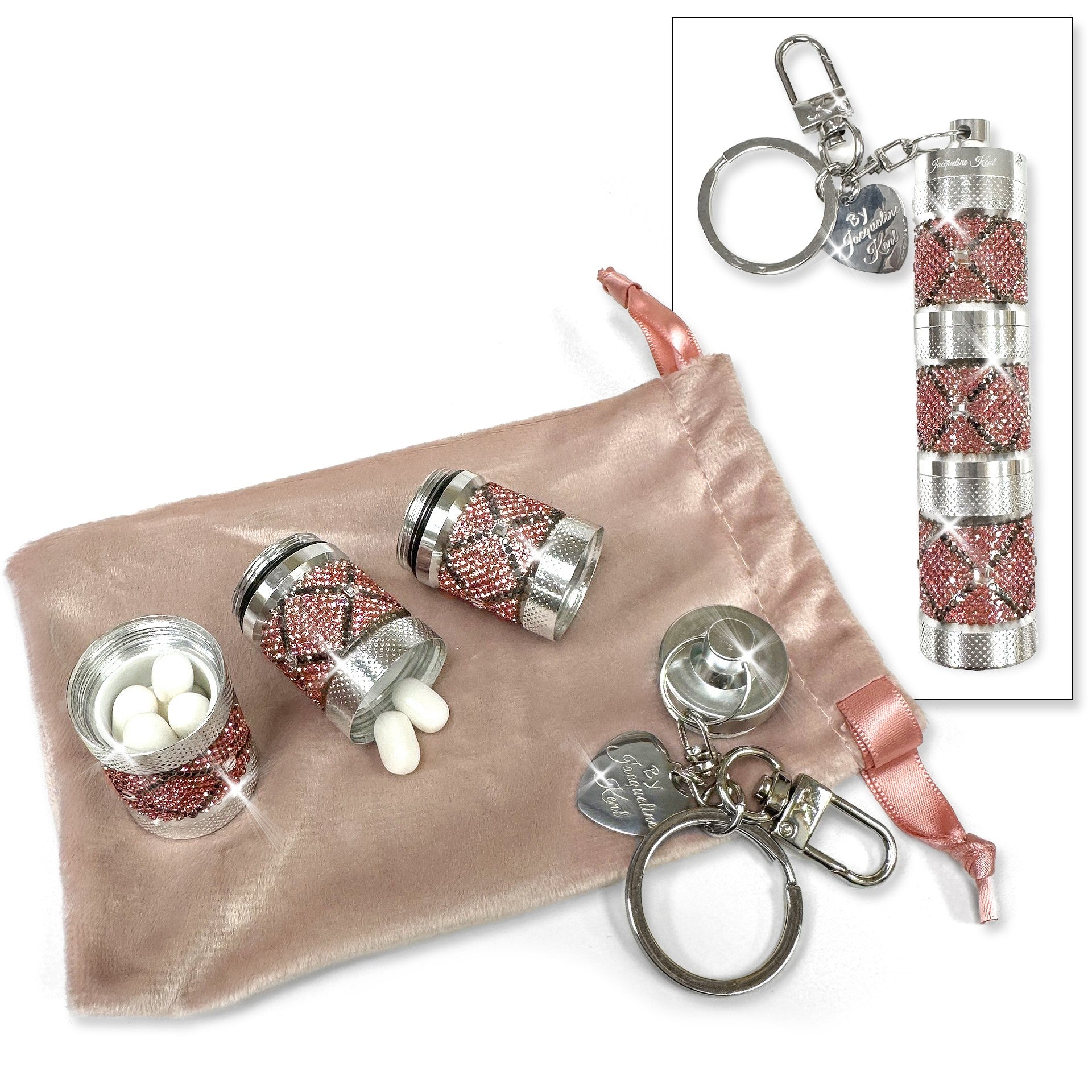 Silver and pink decorative pill containers with keychains on a pink pouch